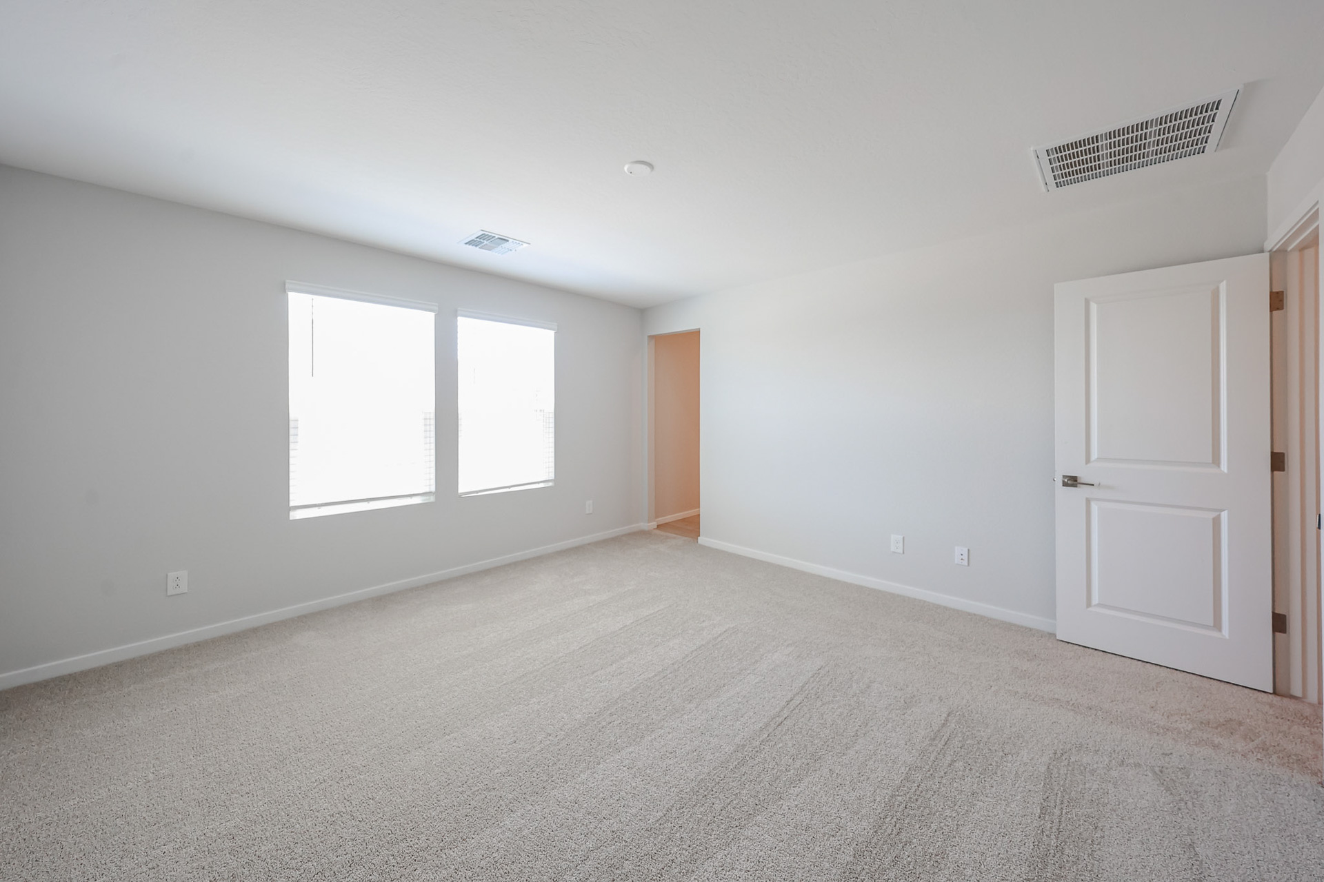 A room with white walls and a carpeted floor.