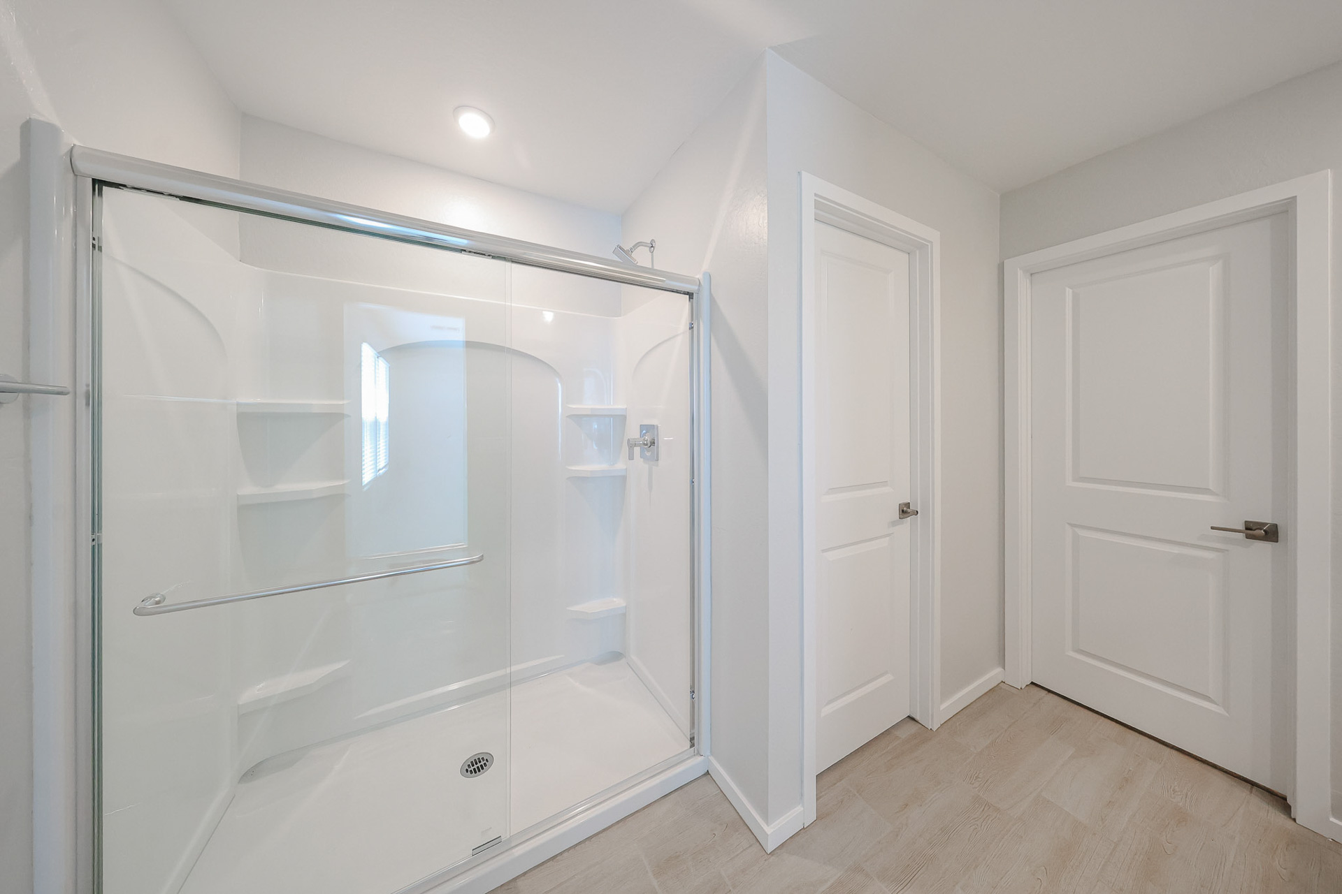 A bathroom with white doors.