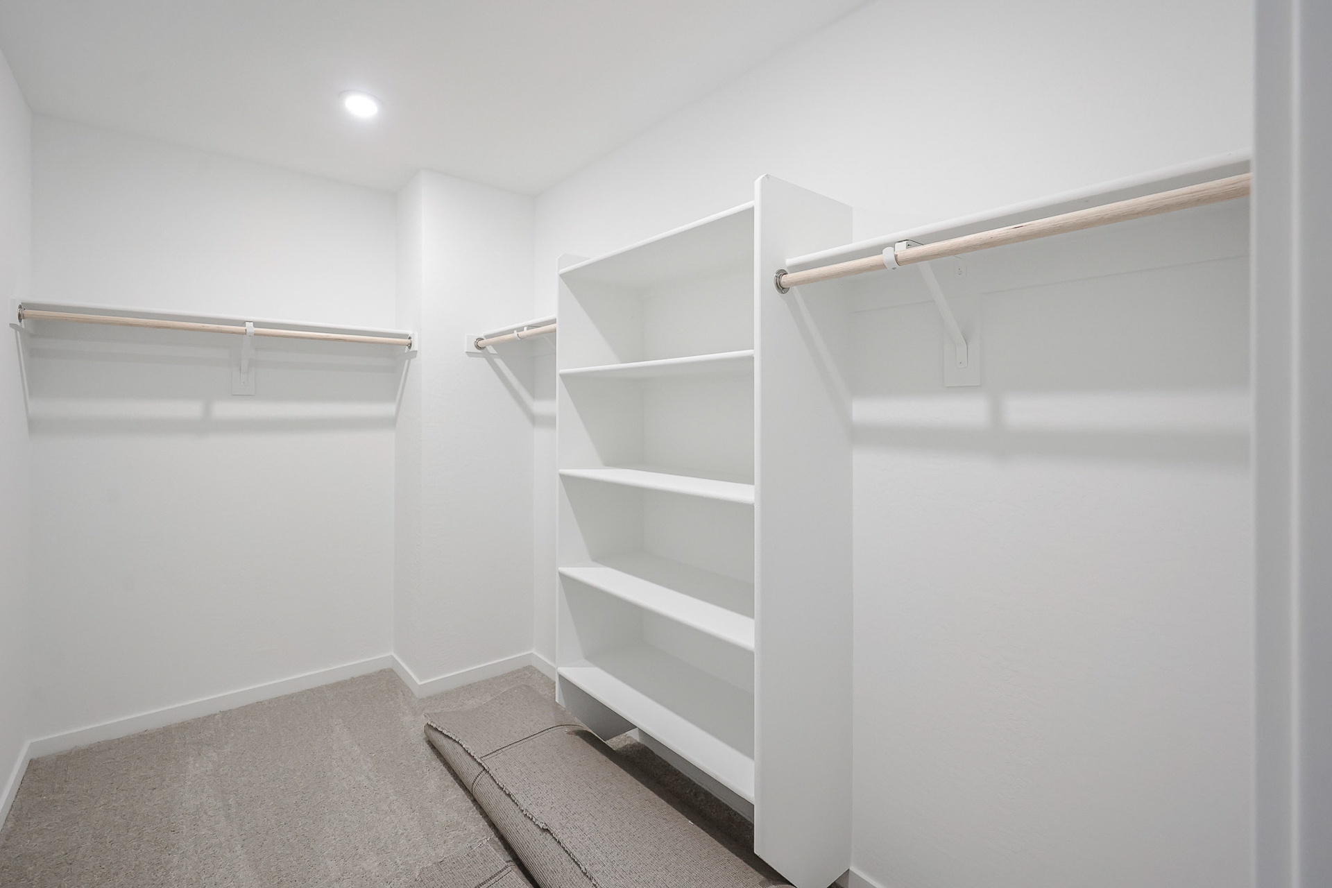 A white room with a white shelf.