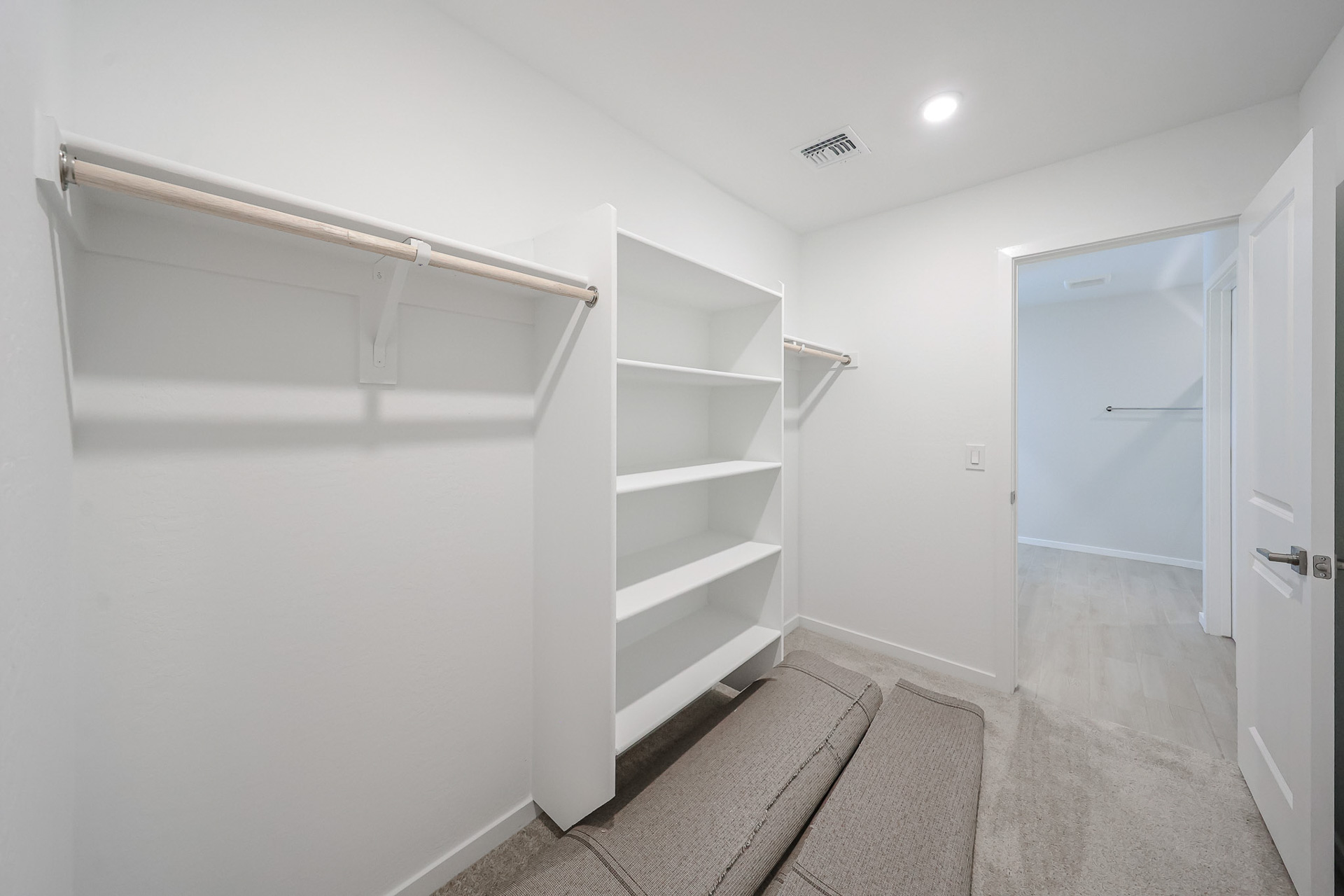 A white room with a white wall and a white door.