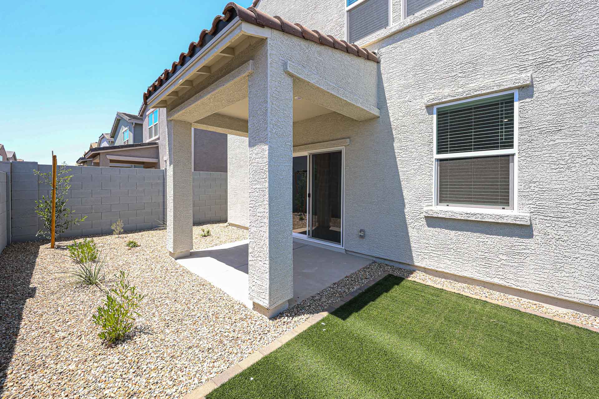 A house with a stone patio.