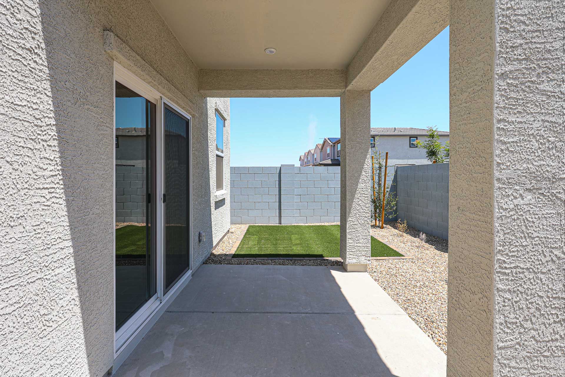 A building with a walkway and grass.