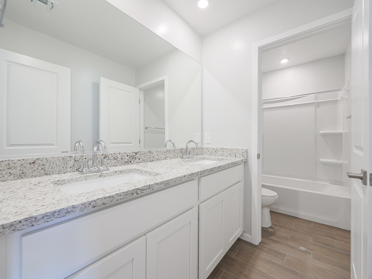 A bathroom with a marble countertop.