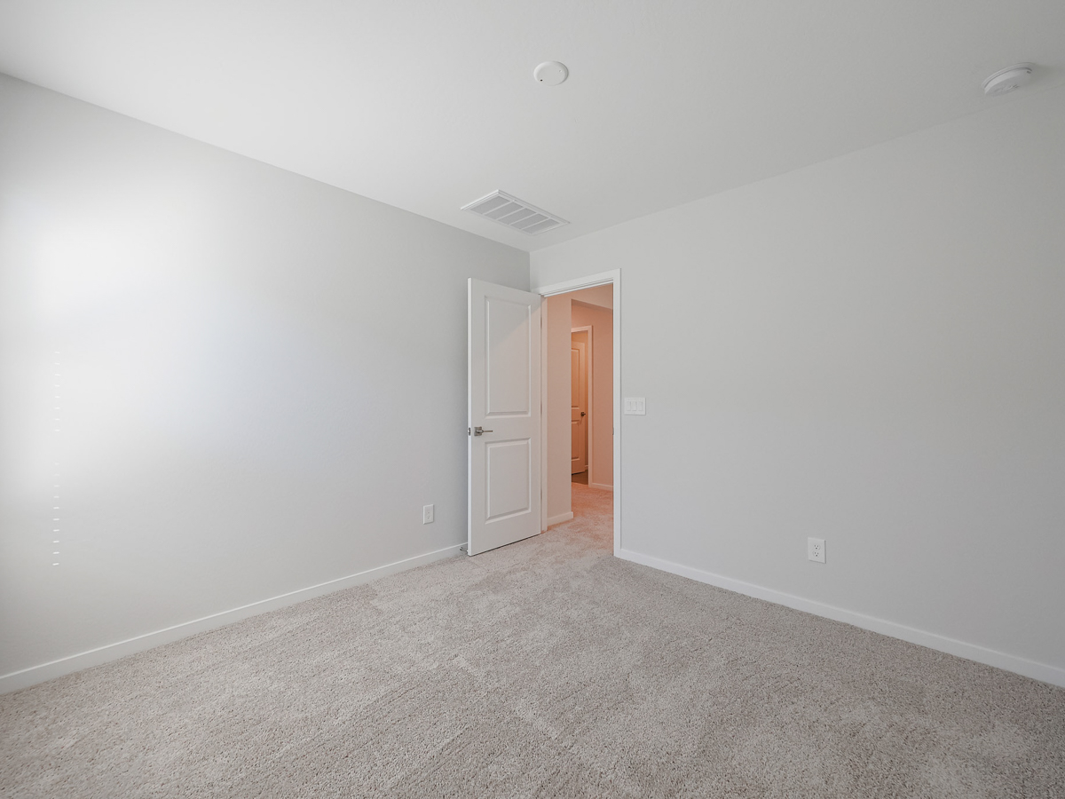A hallway with white walls.