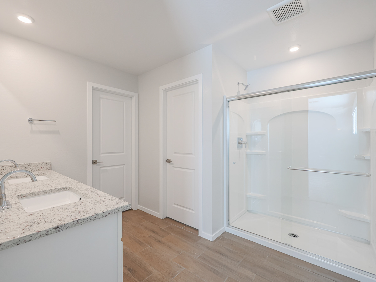 A bathroom with a tub sink and a shower.