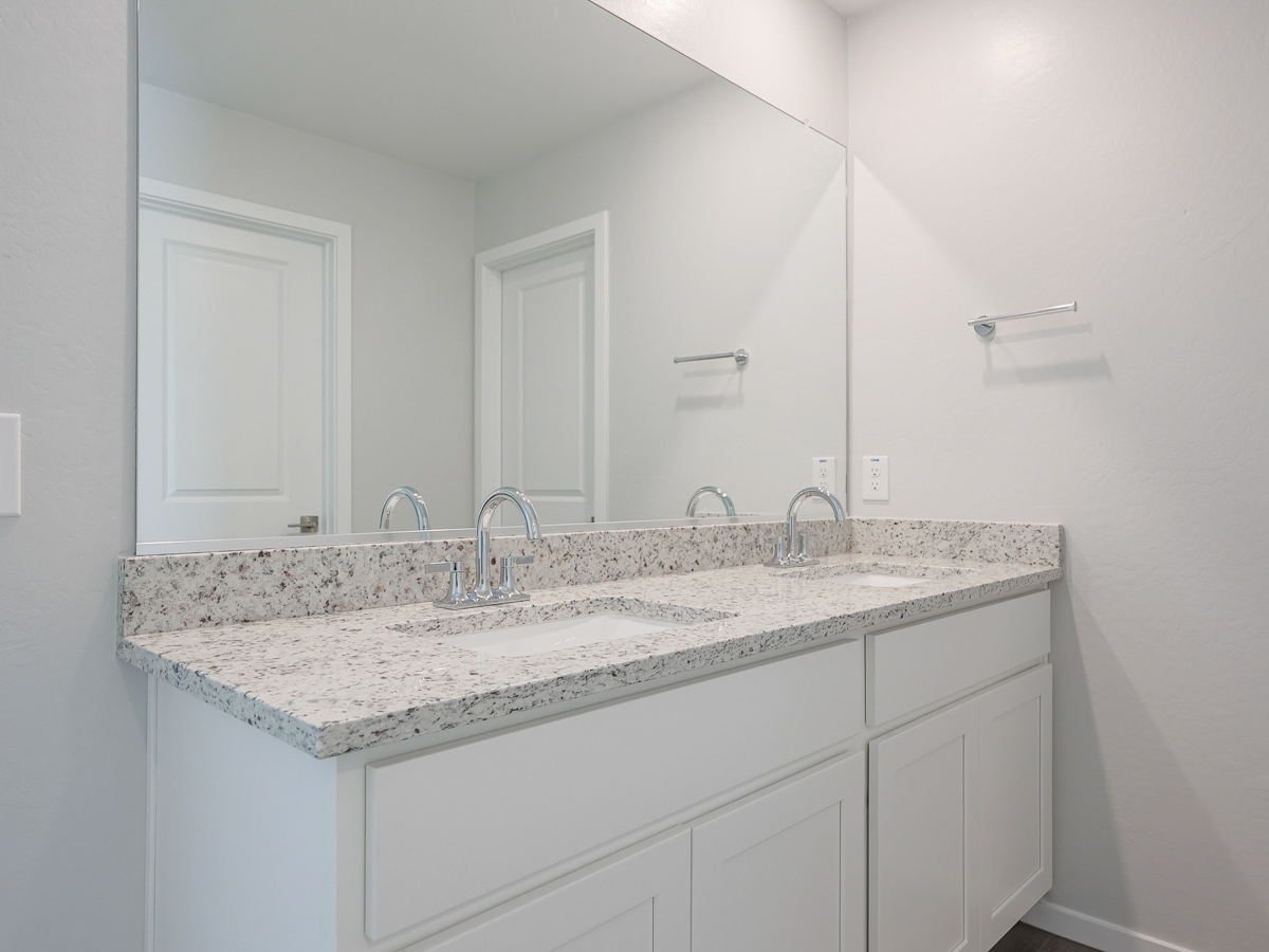 A bathroom with a marble countertop.