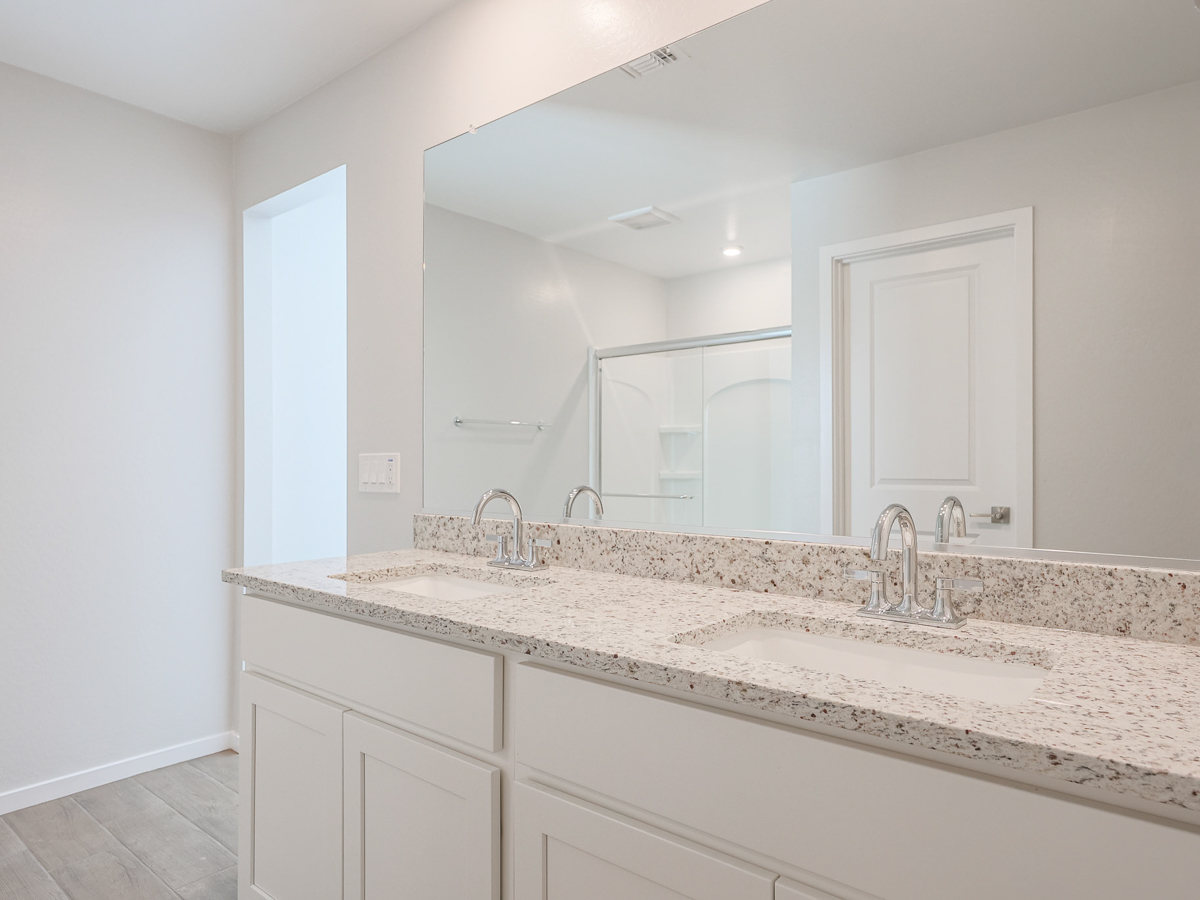 A bathroom with a large mirror.