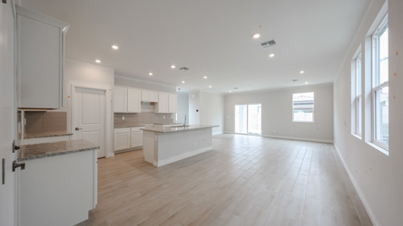 A large kitchen with white cabinets.