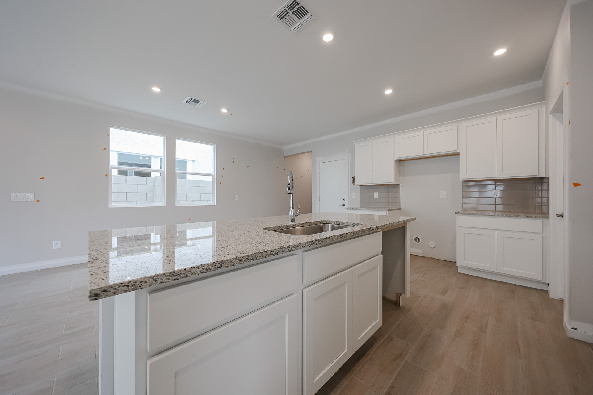 A kitchen with white cabinets.