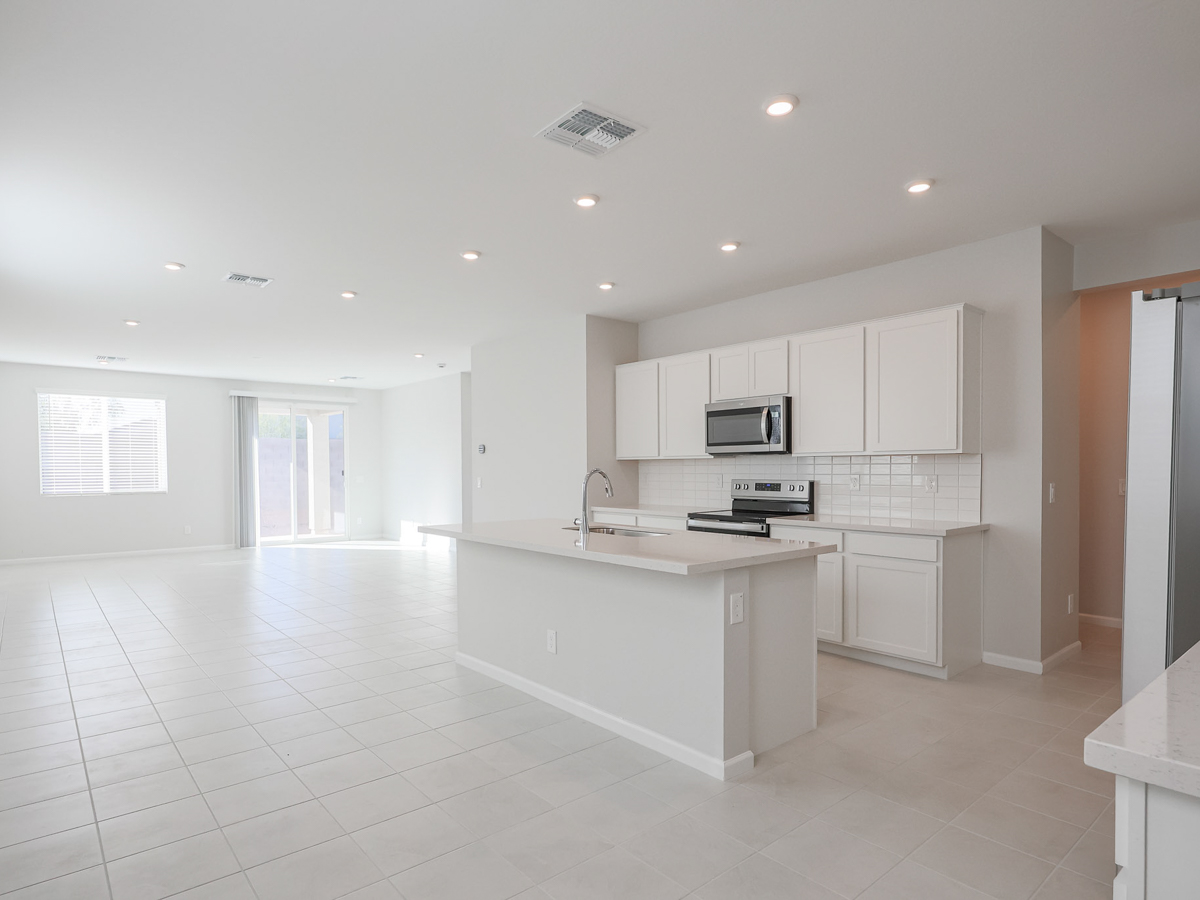 A kitchen with white cabinets.