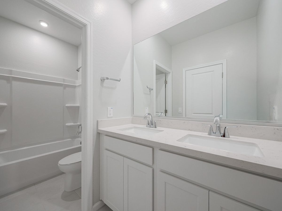 A bathroom with a tub sink and toilet.