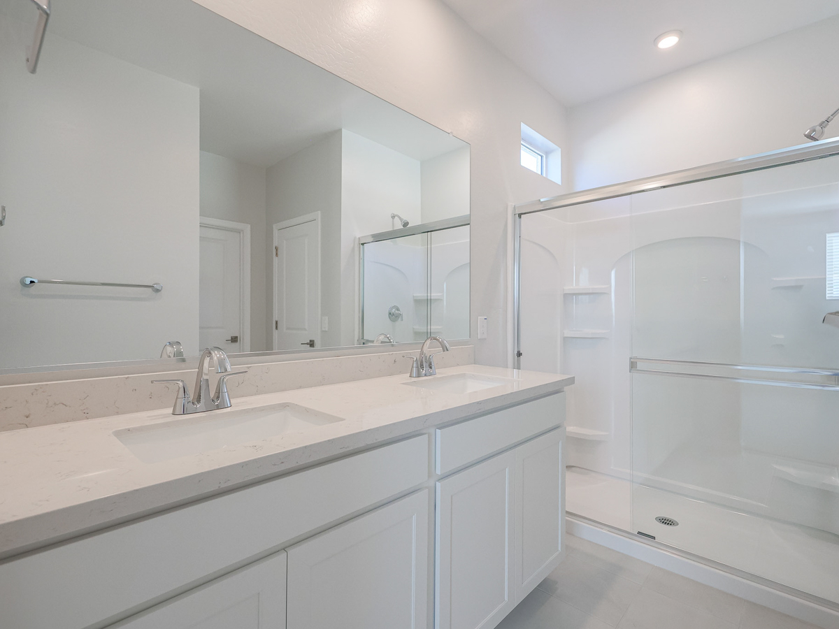 A bathroom with a large mirror.