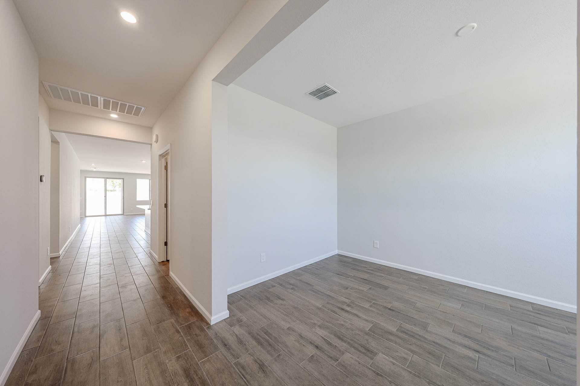 A long hallway with white walls.