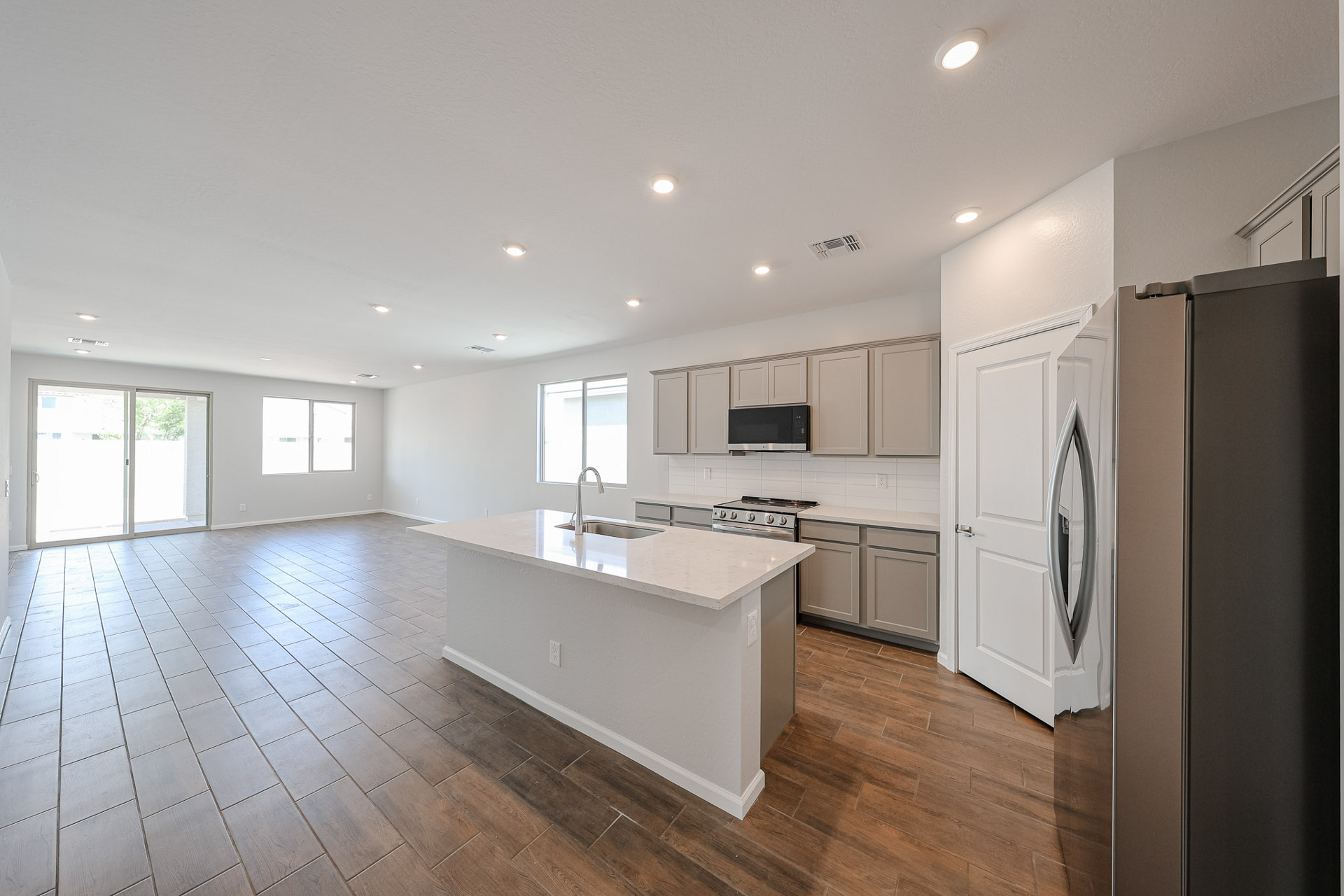 A kitchen with white cabinets.