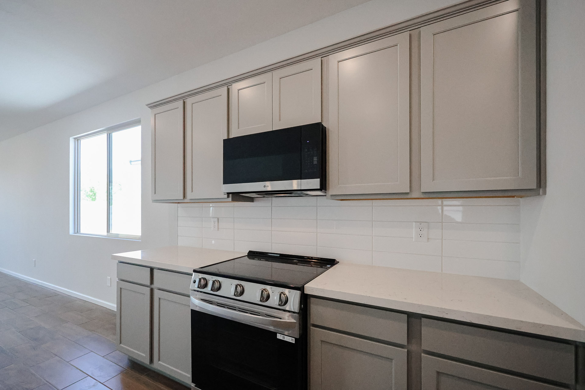 A kitchen with white cabinets.
