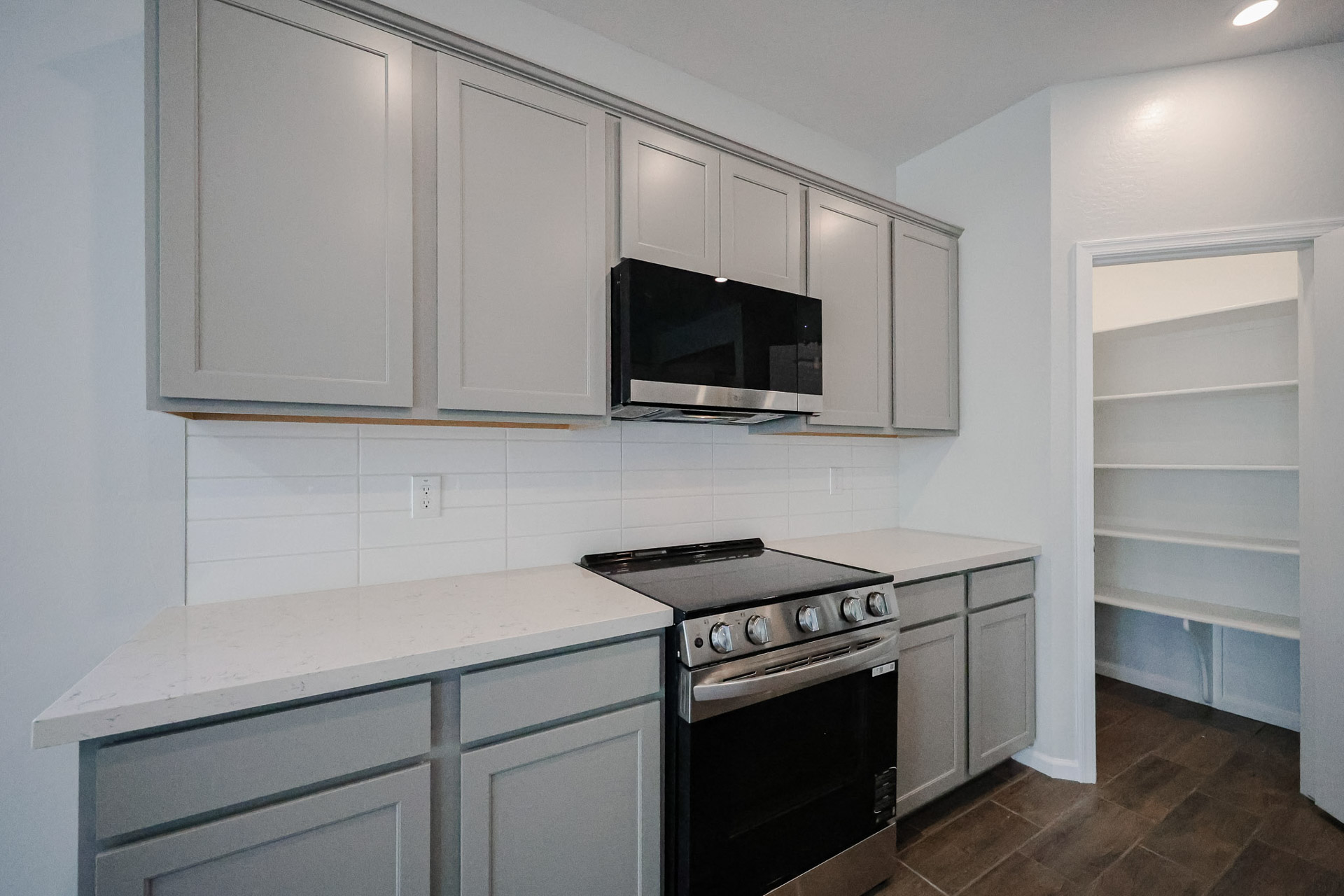 A kitchen with white cabinets.