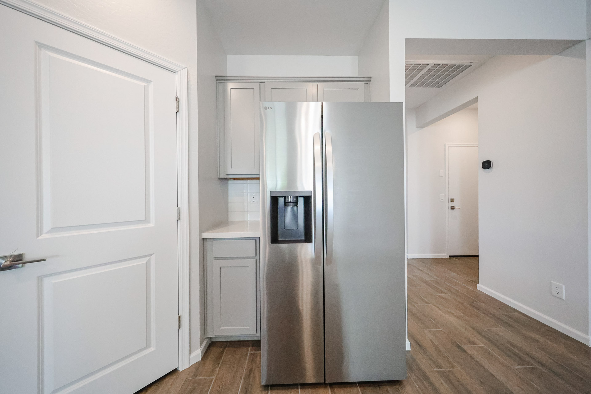 A kitchen with white cabinets.
