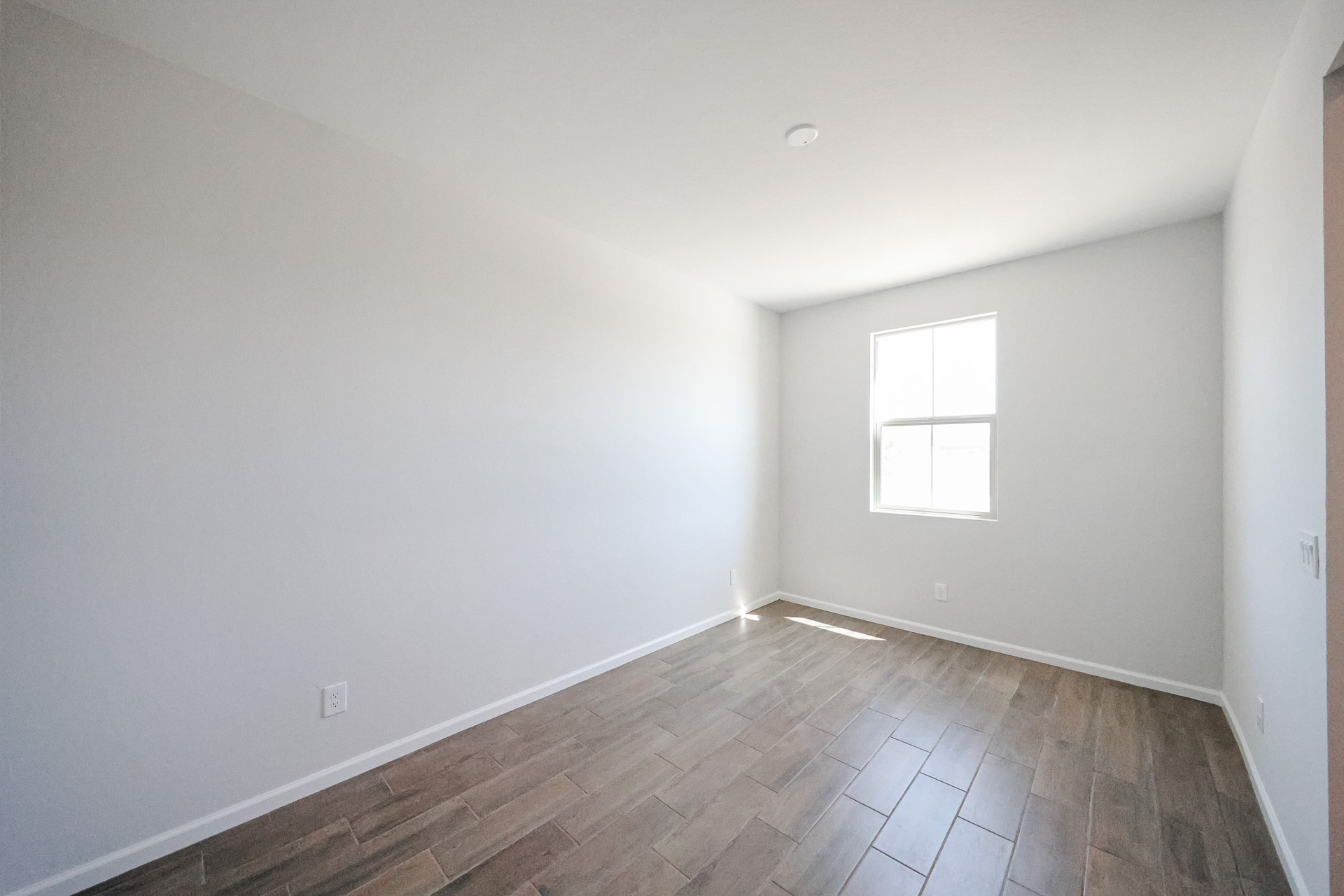 A room with a tile floor and windows.