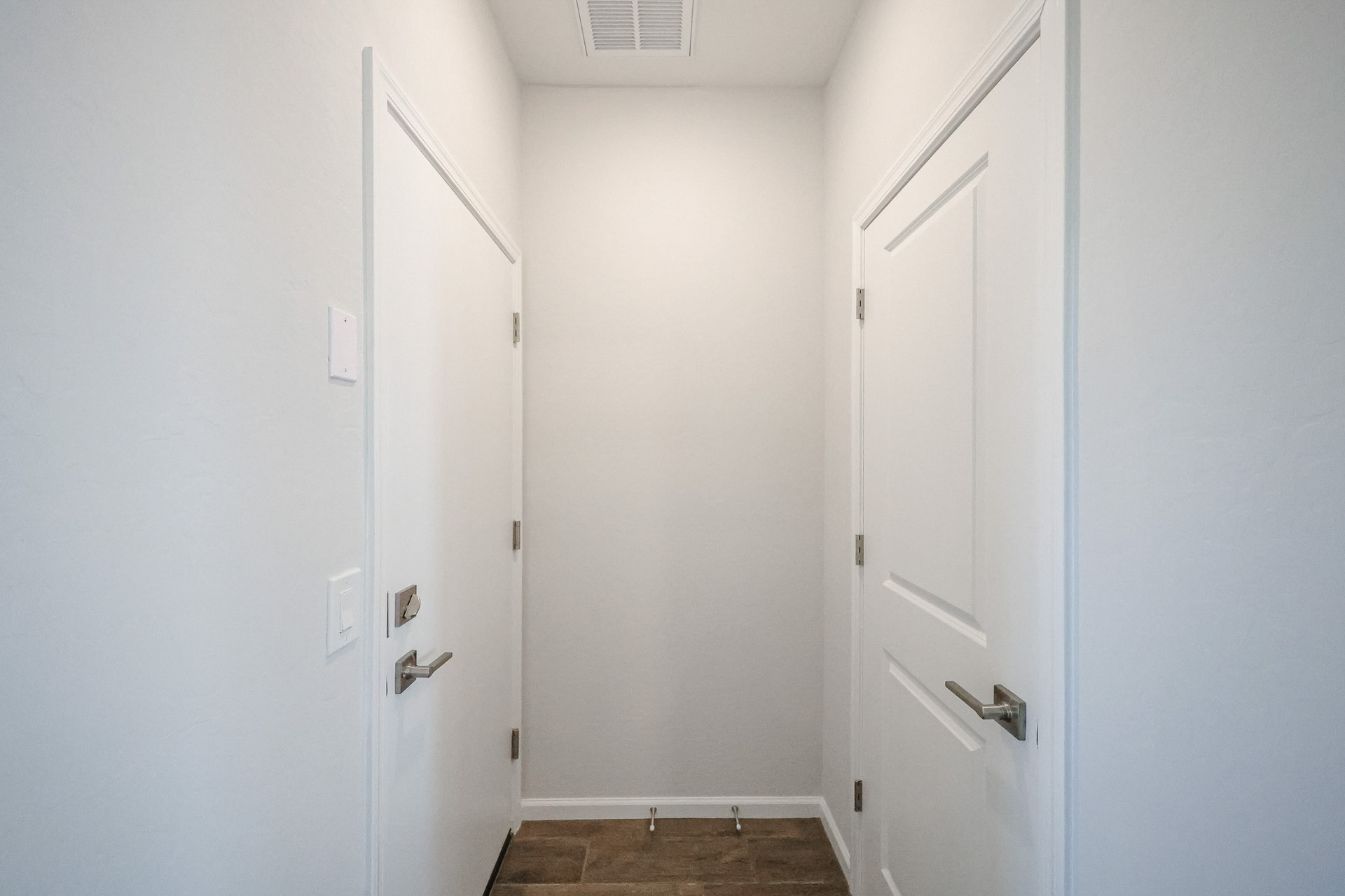 A hallway with white doors.
