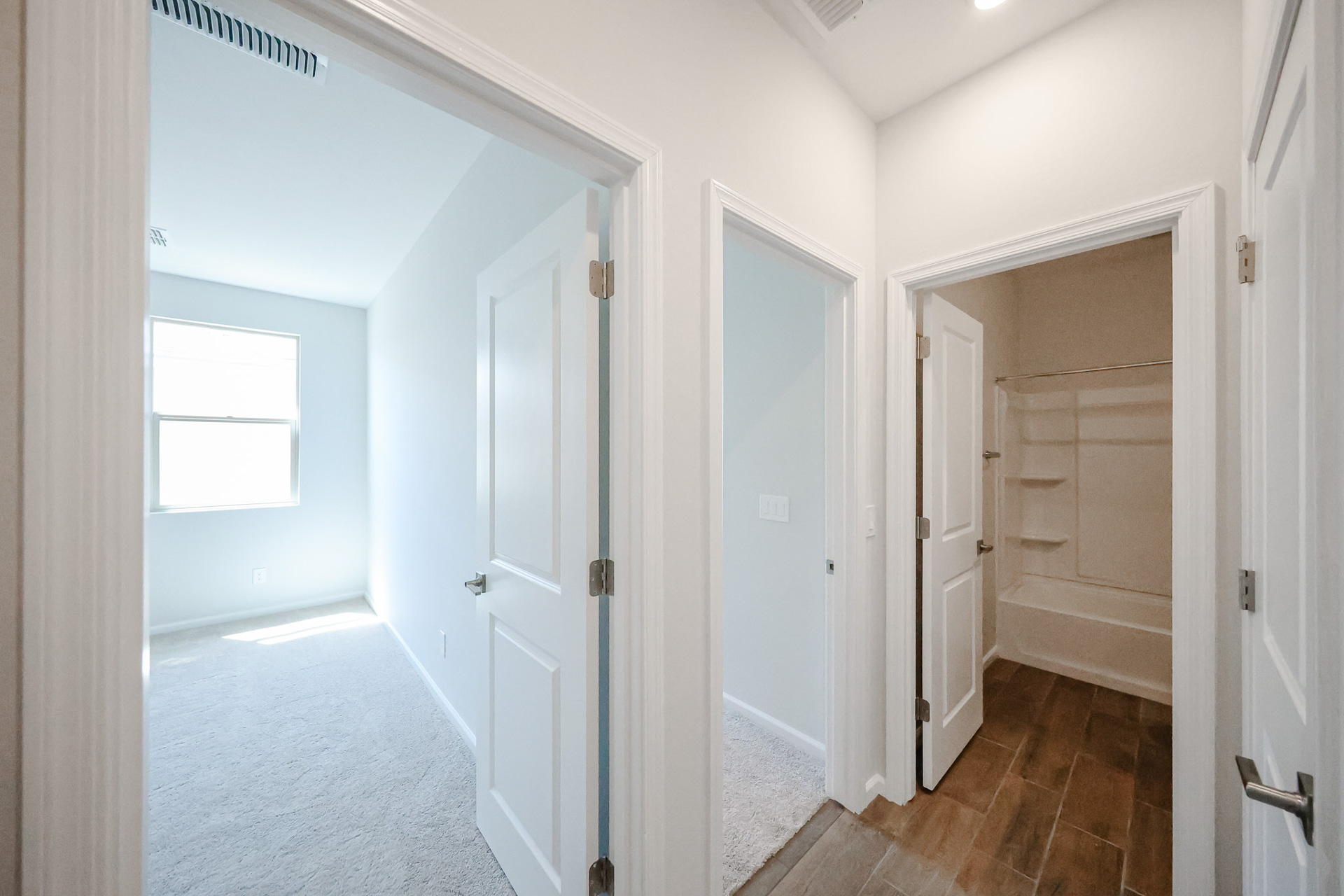 A hallway with white doors.