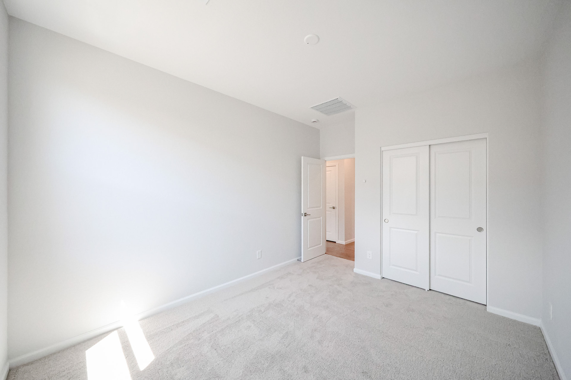 A hallway with white doors.