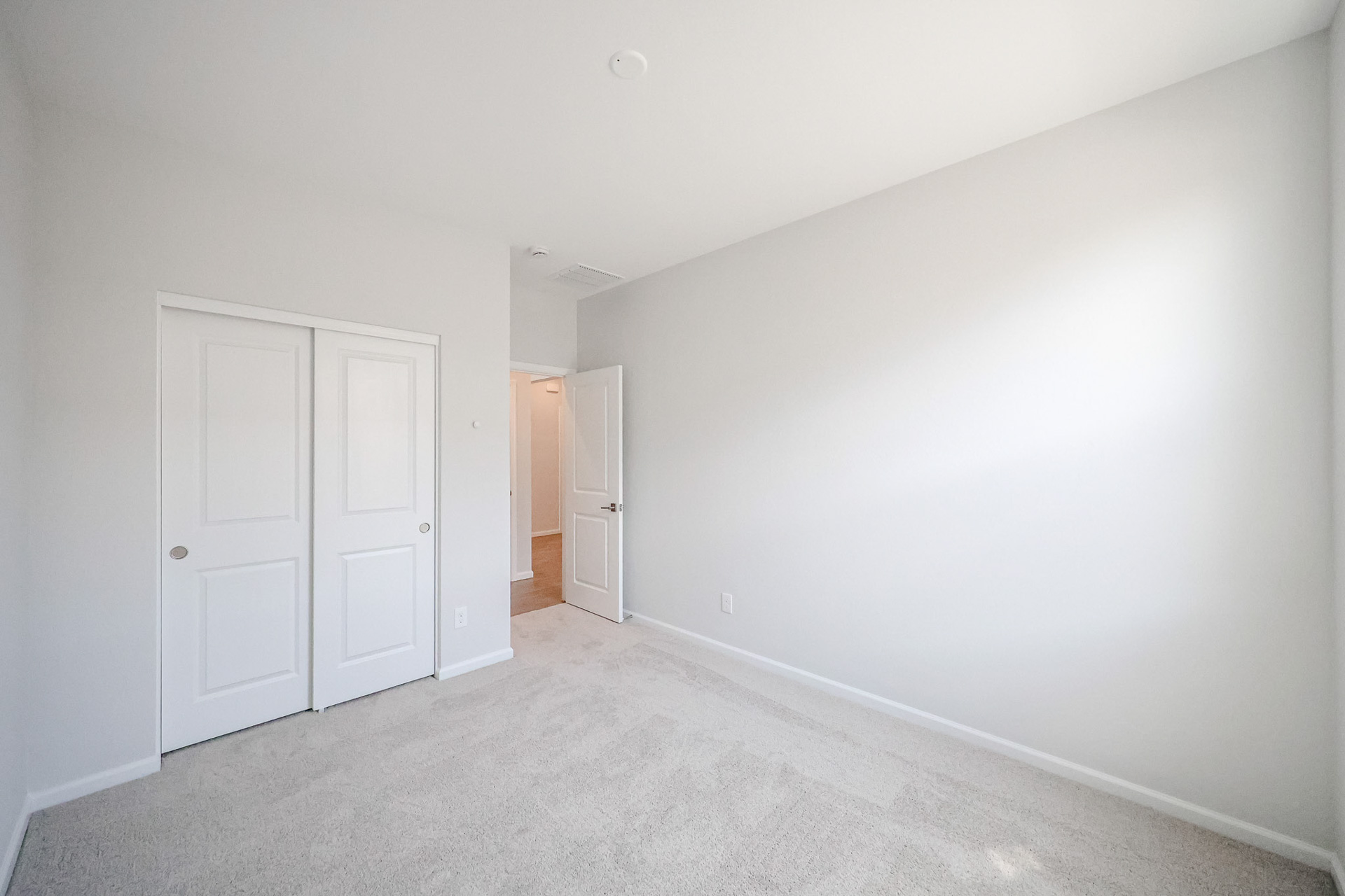 A hallway with white doors.