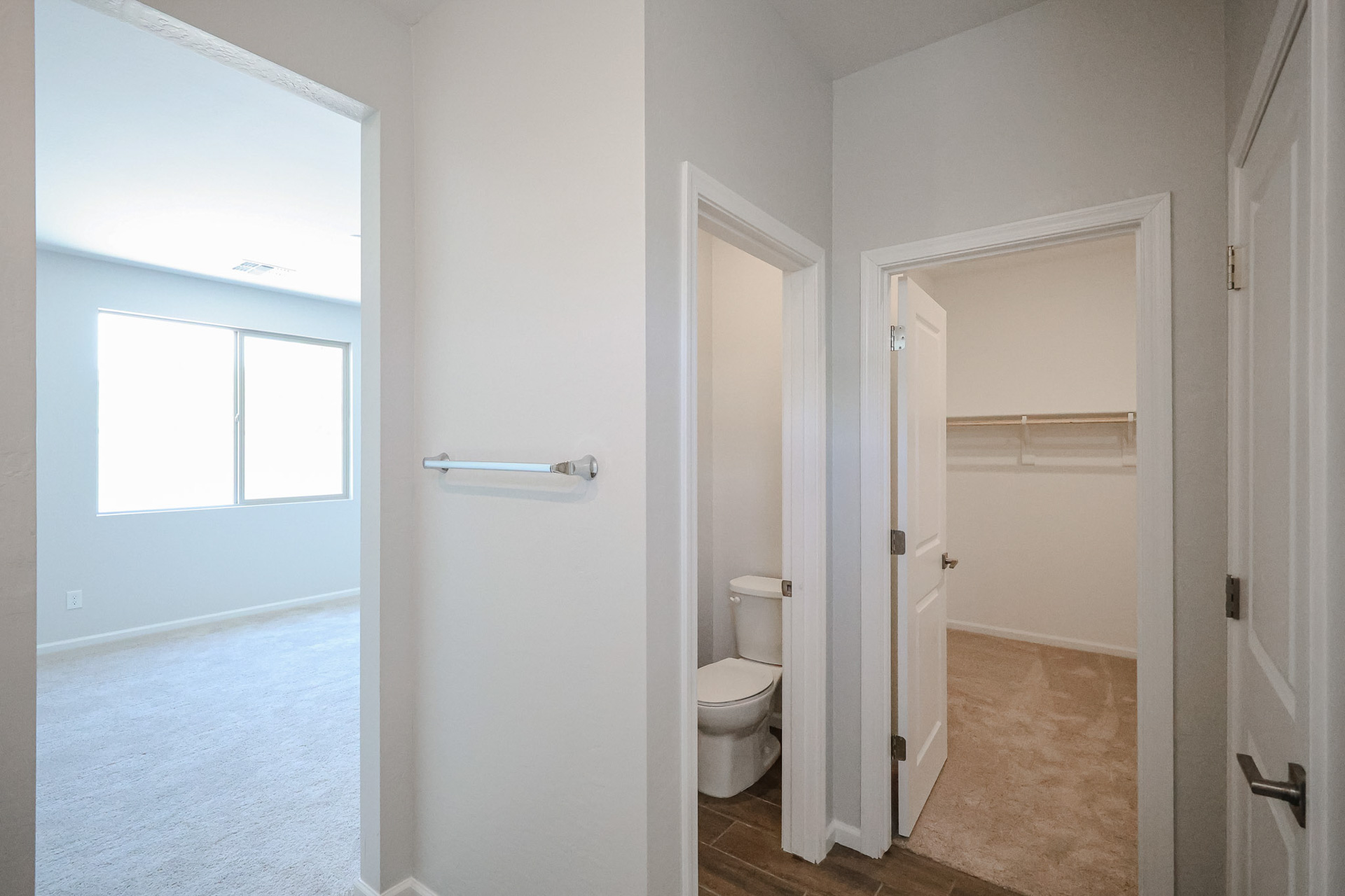 A bathroom with a toilet and a shower.
