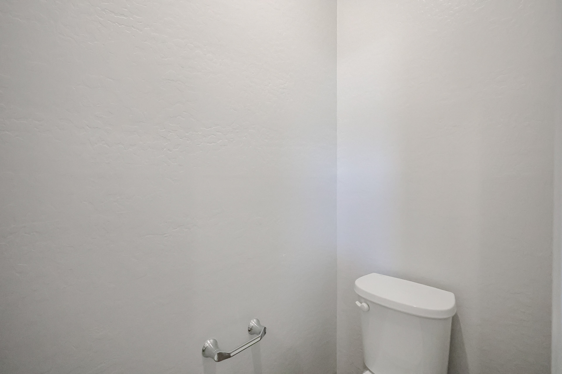 A toilet in a bathroom.