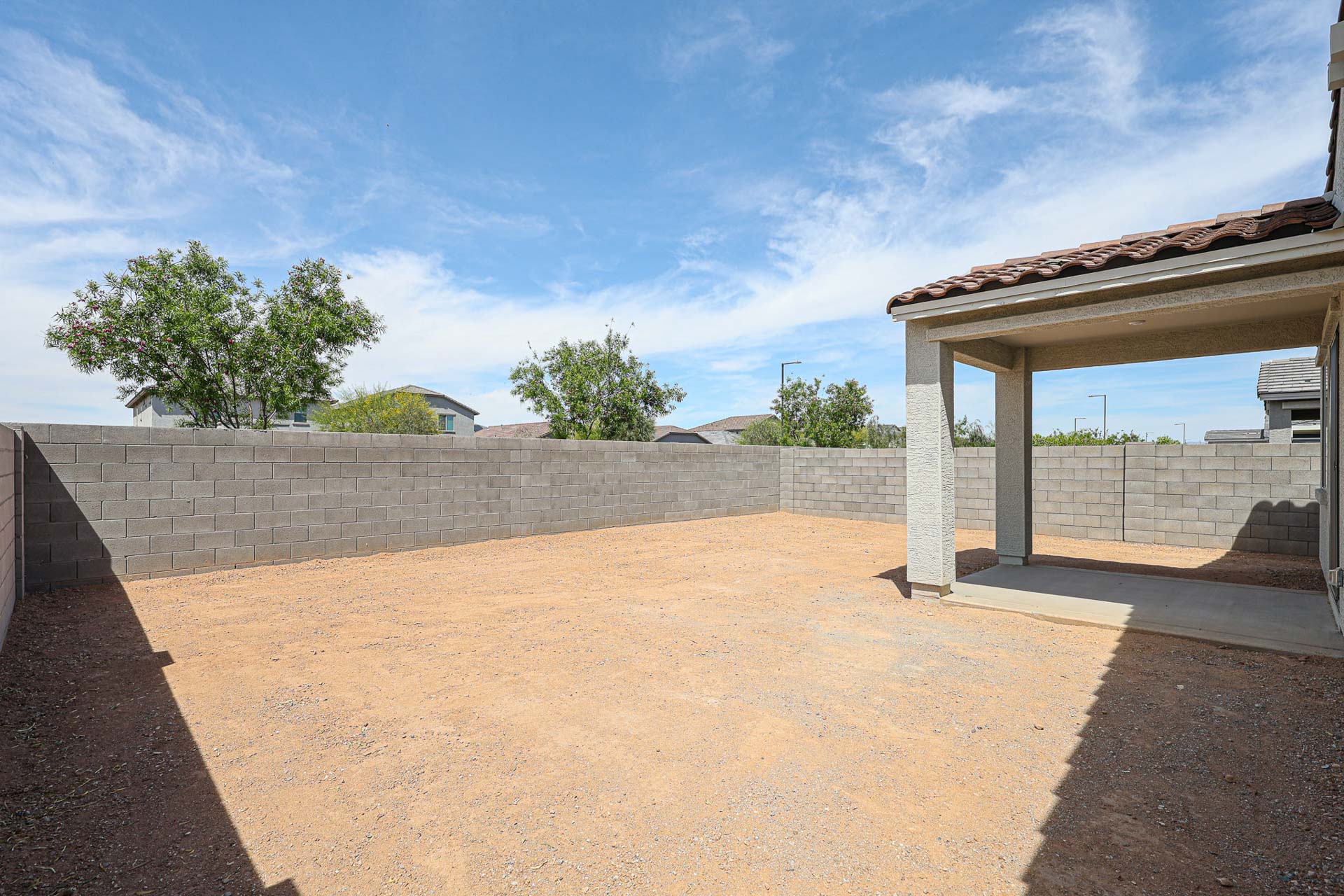 A concrete wall with a stone wall and a stone wall with trees.