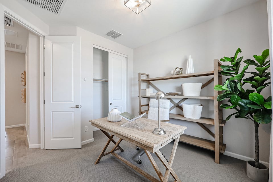 A room with a table and shelves.