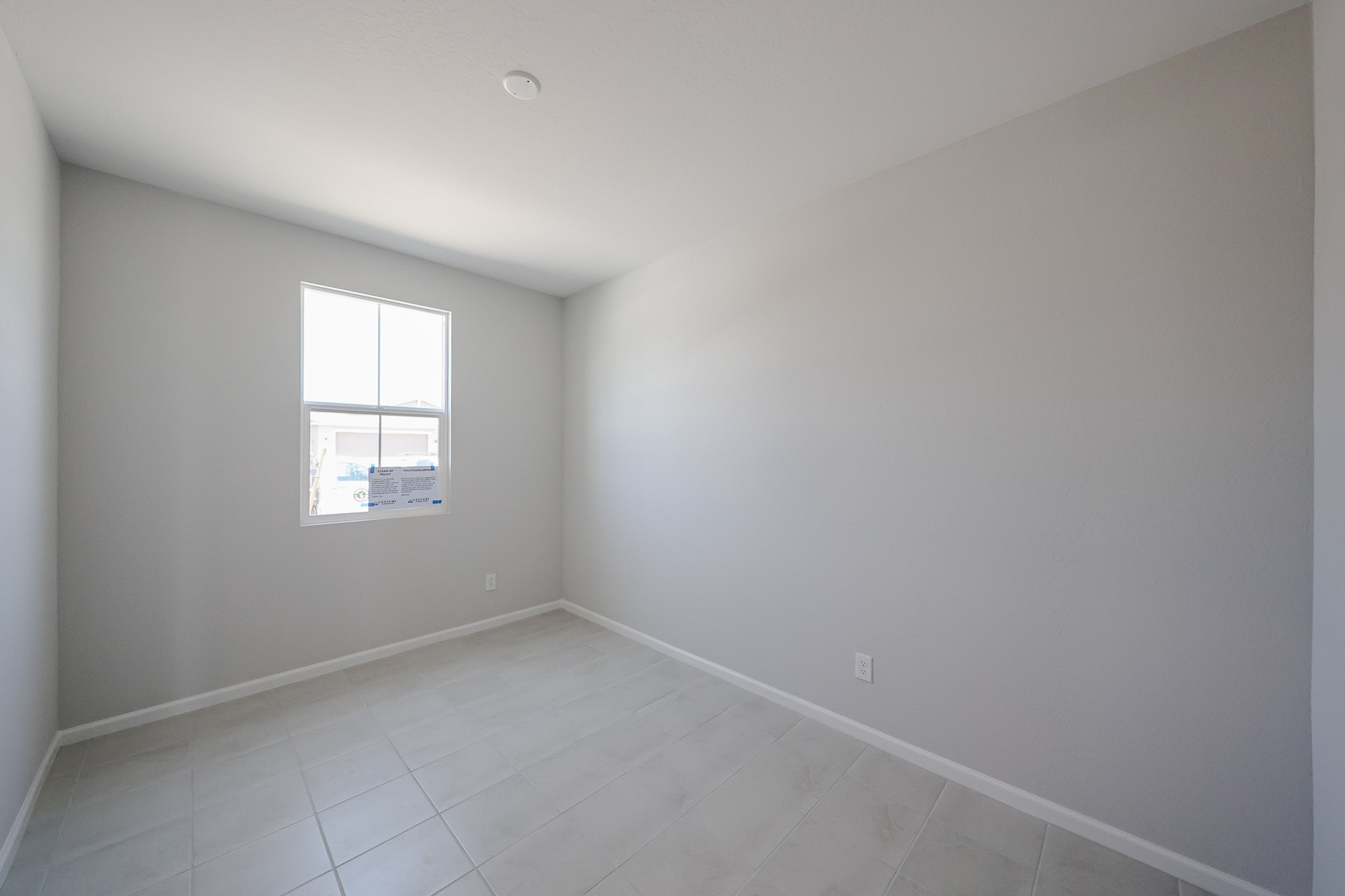 A room with a tile floor and a window.