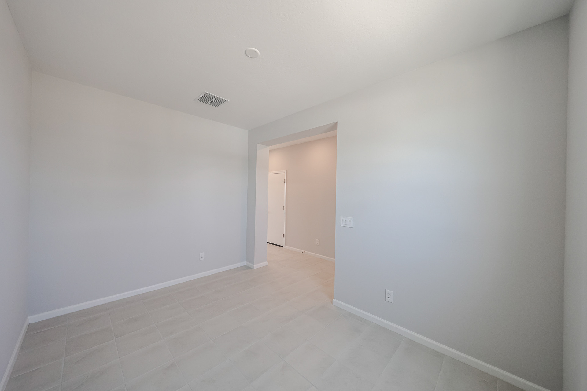 A hallway with white walls.