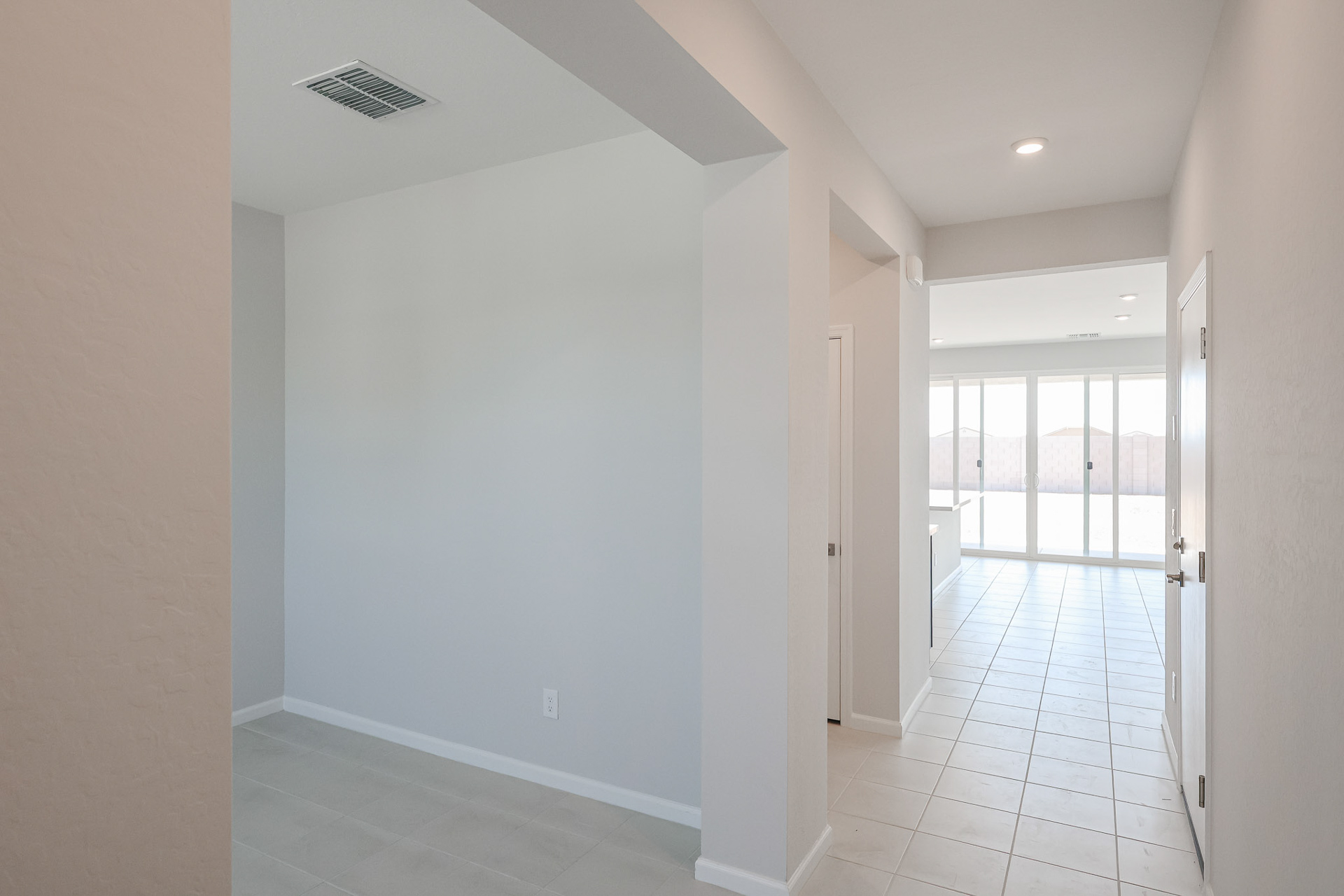 A hallway with white walls.