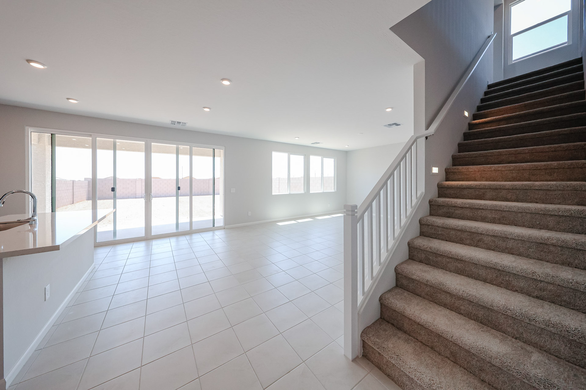 A large room with a staircase.