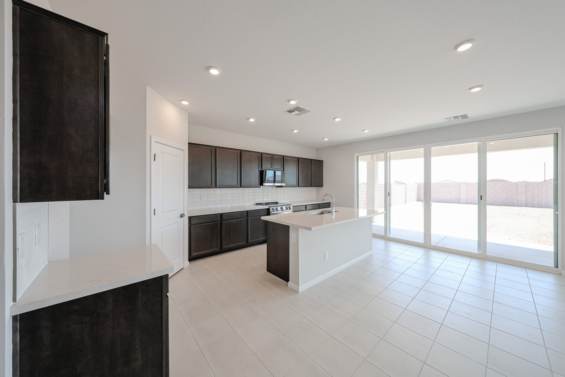 A kitchen with black cabinets.