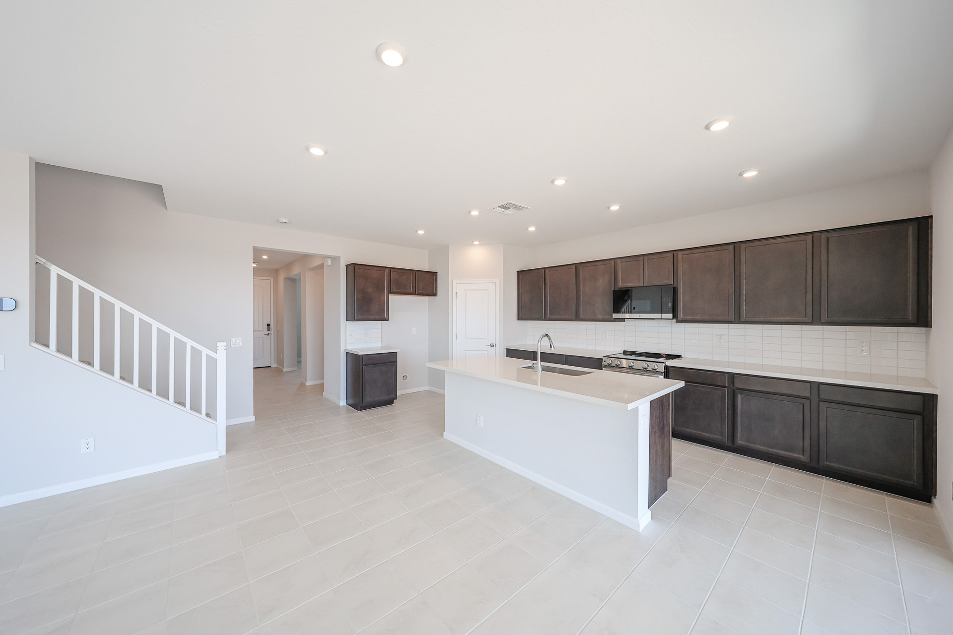 A kitchen with black cabinets.