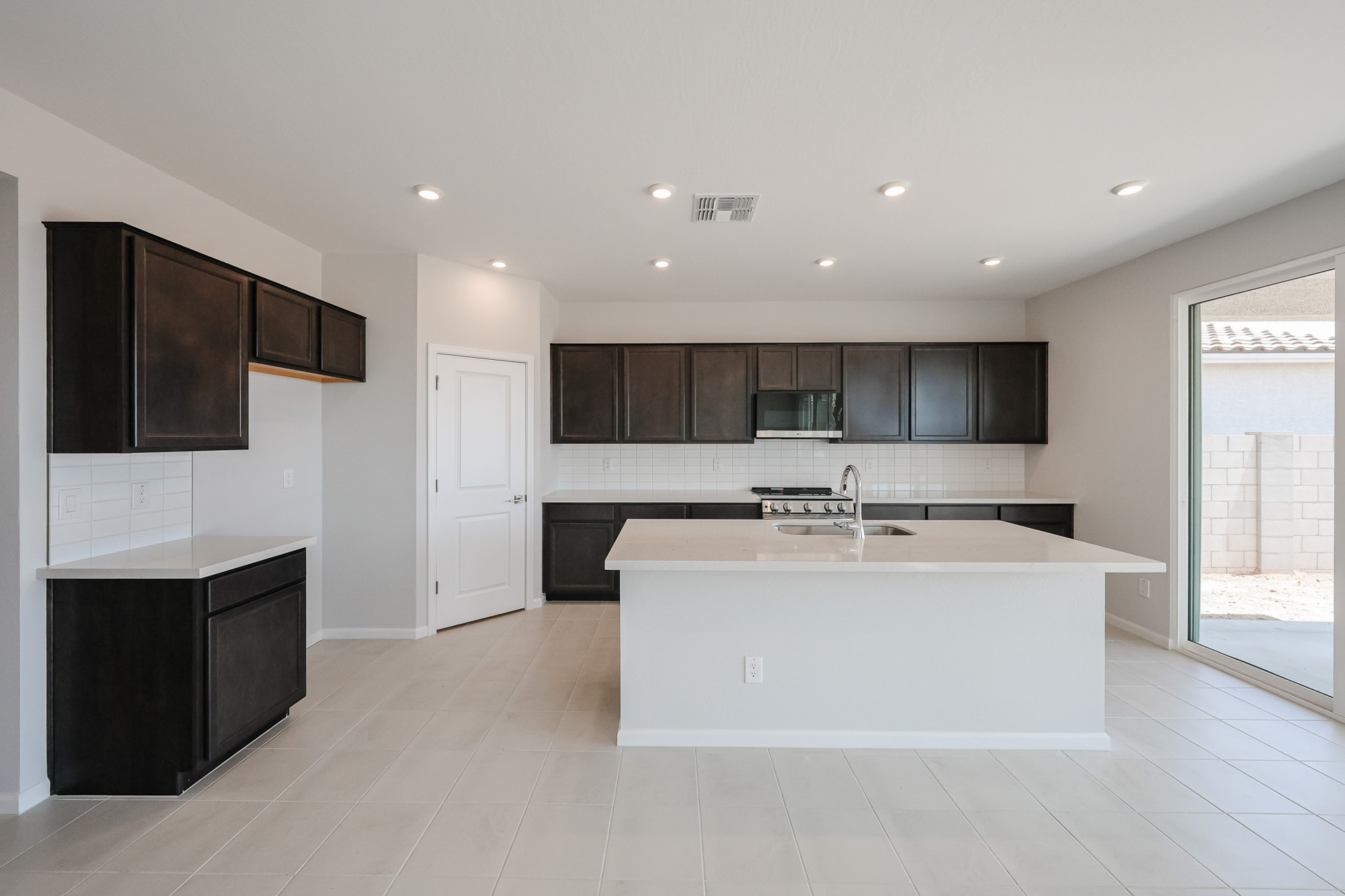A kitchen with black cabinets.