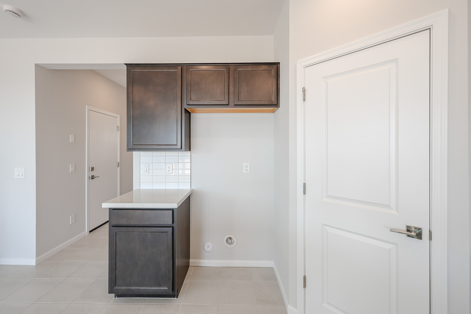 A room with white cabinets and a black countertop.