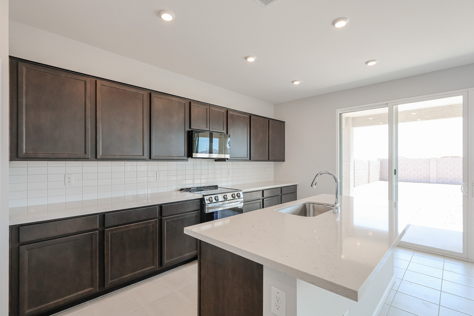 A kitchen with black cabinets.