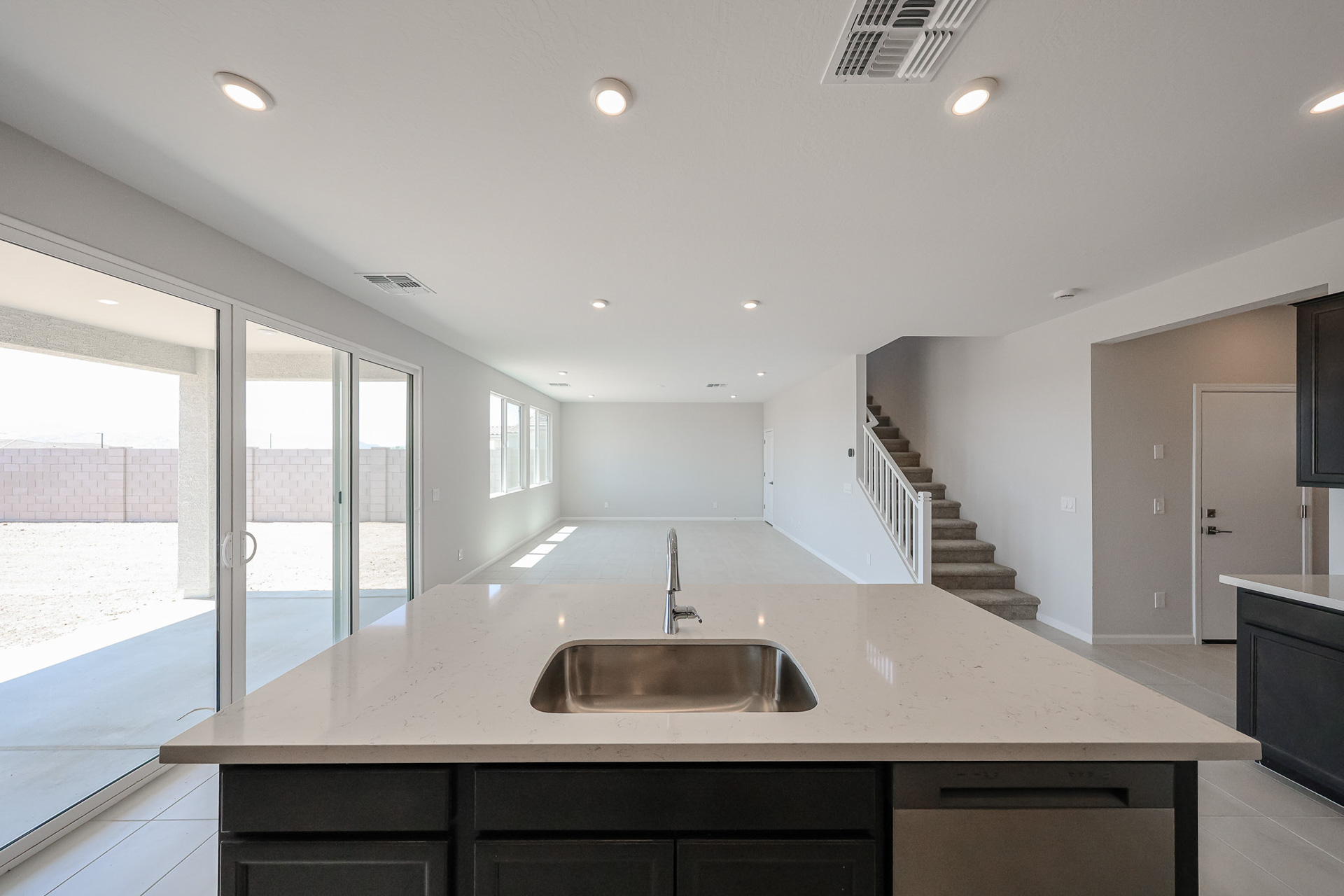 A kitchen with a large glass door.