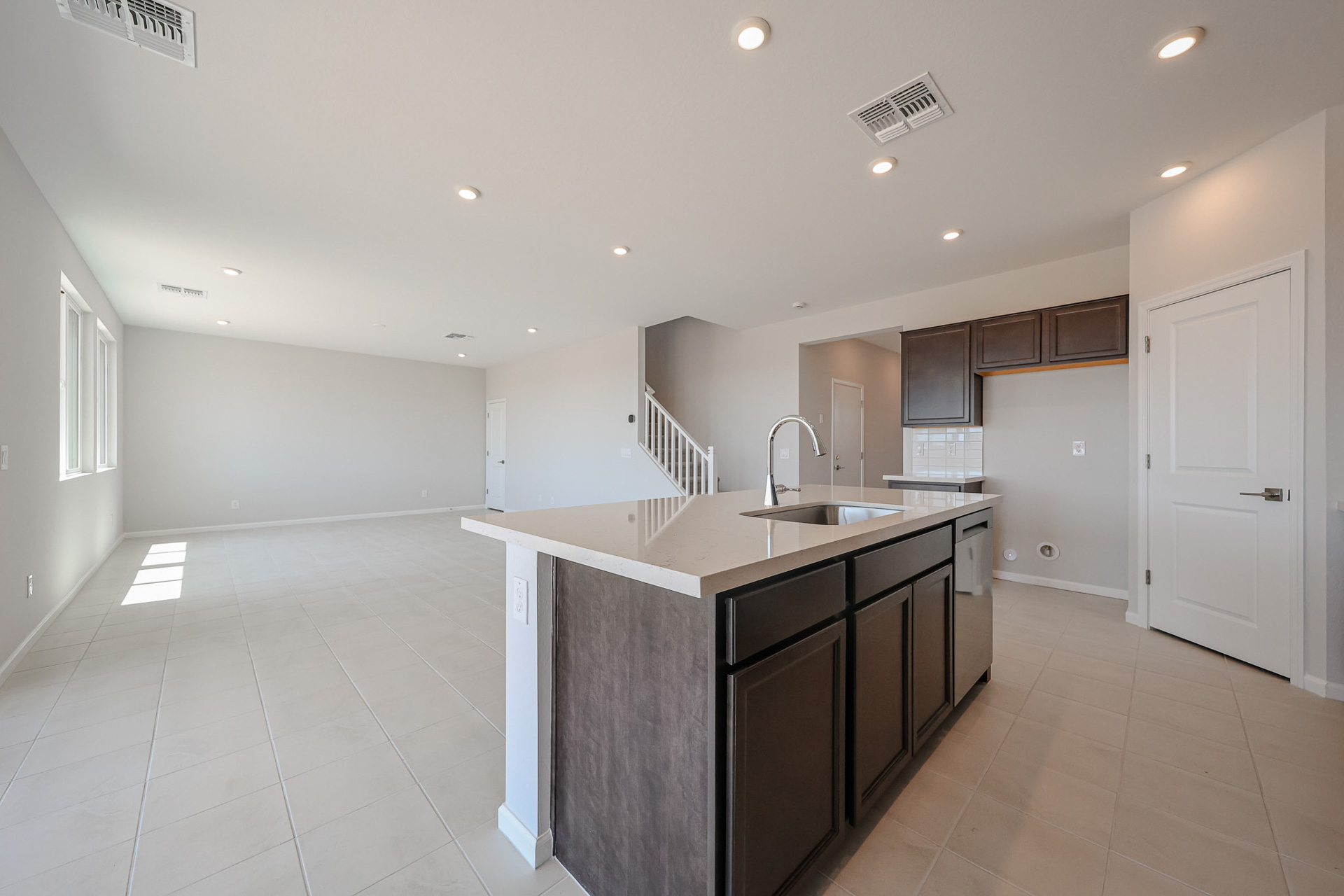 A kitchen with black cabinets.