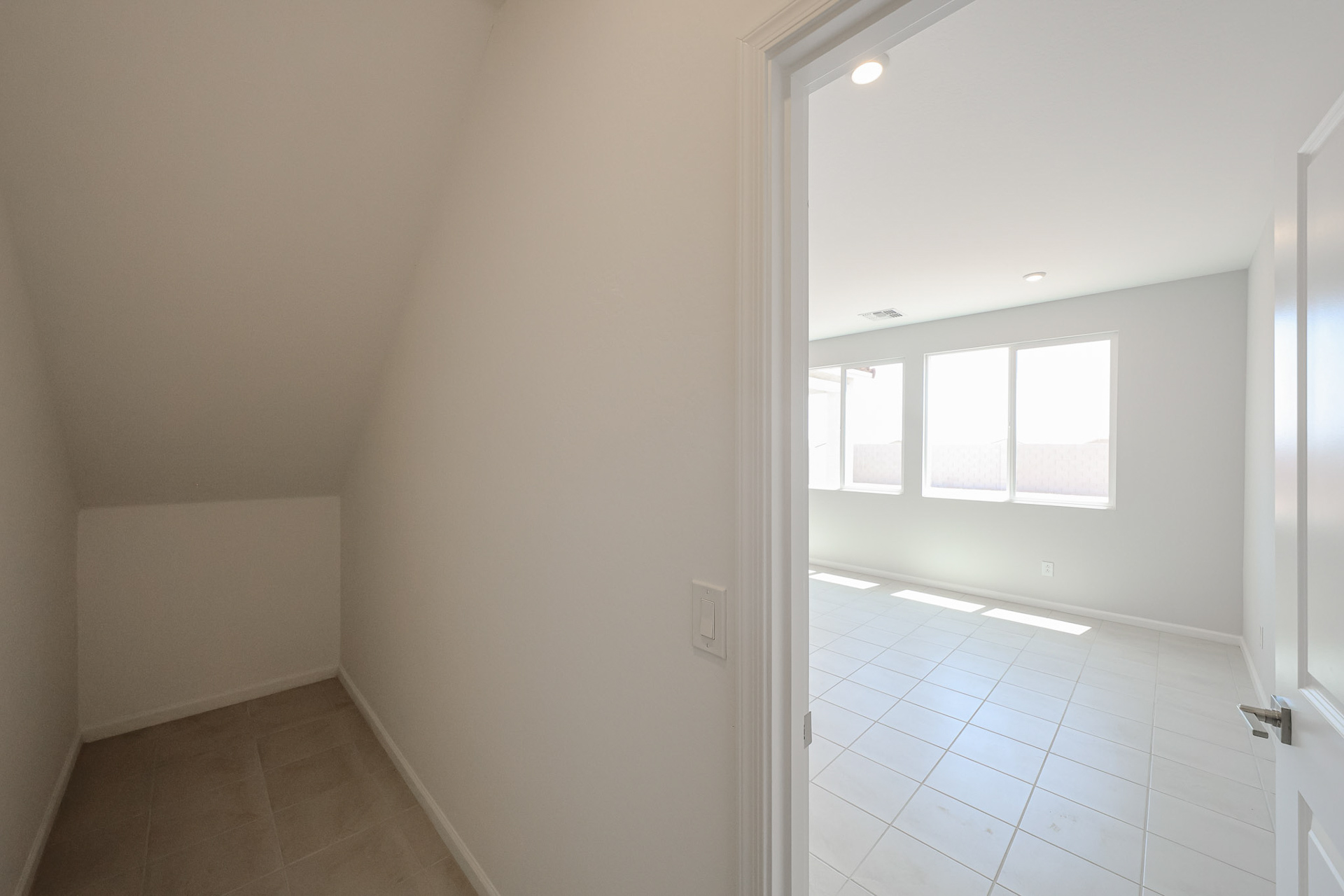 A room with white walls and a white tile floor.