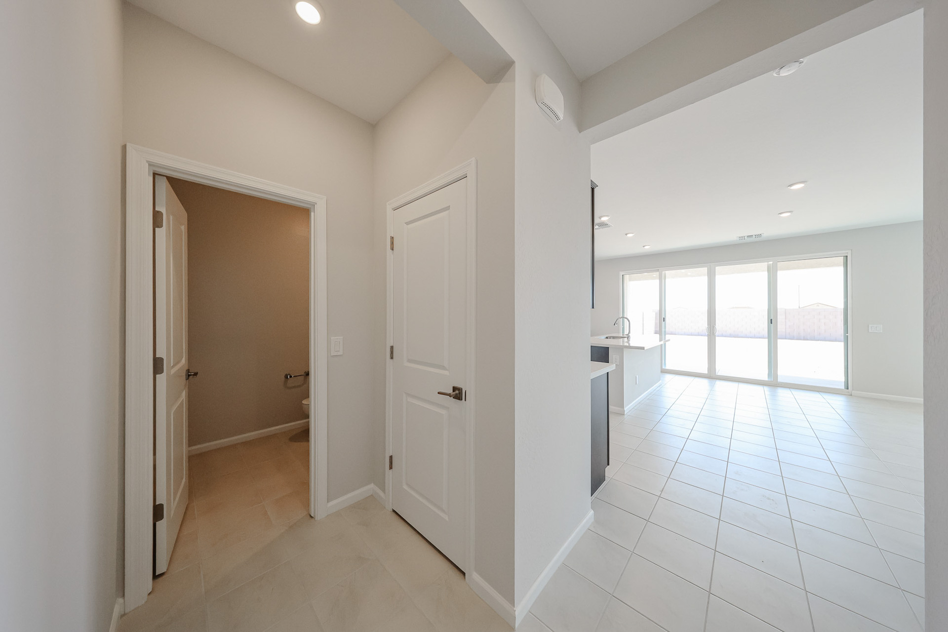 A room with white walls and a white tiled floor.