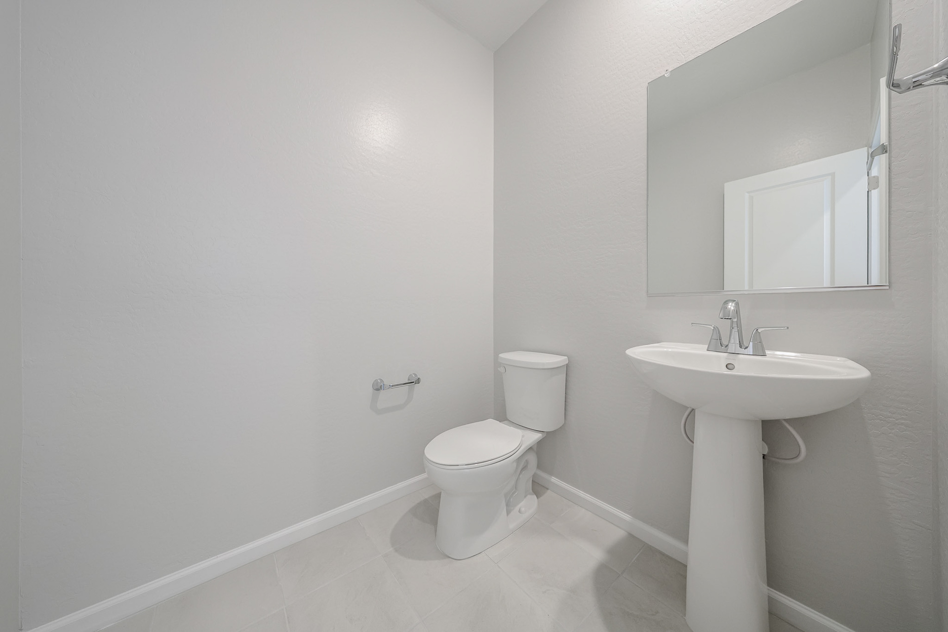 A bathroom with a toilet and sink.