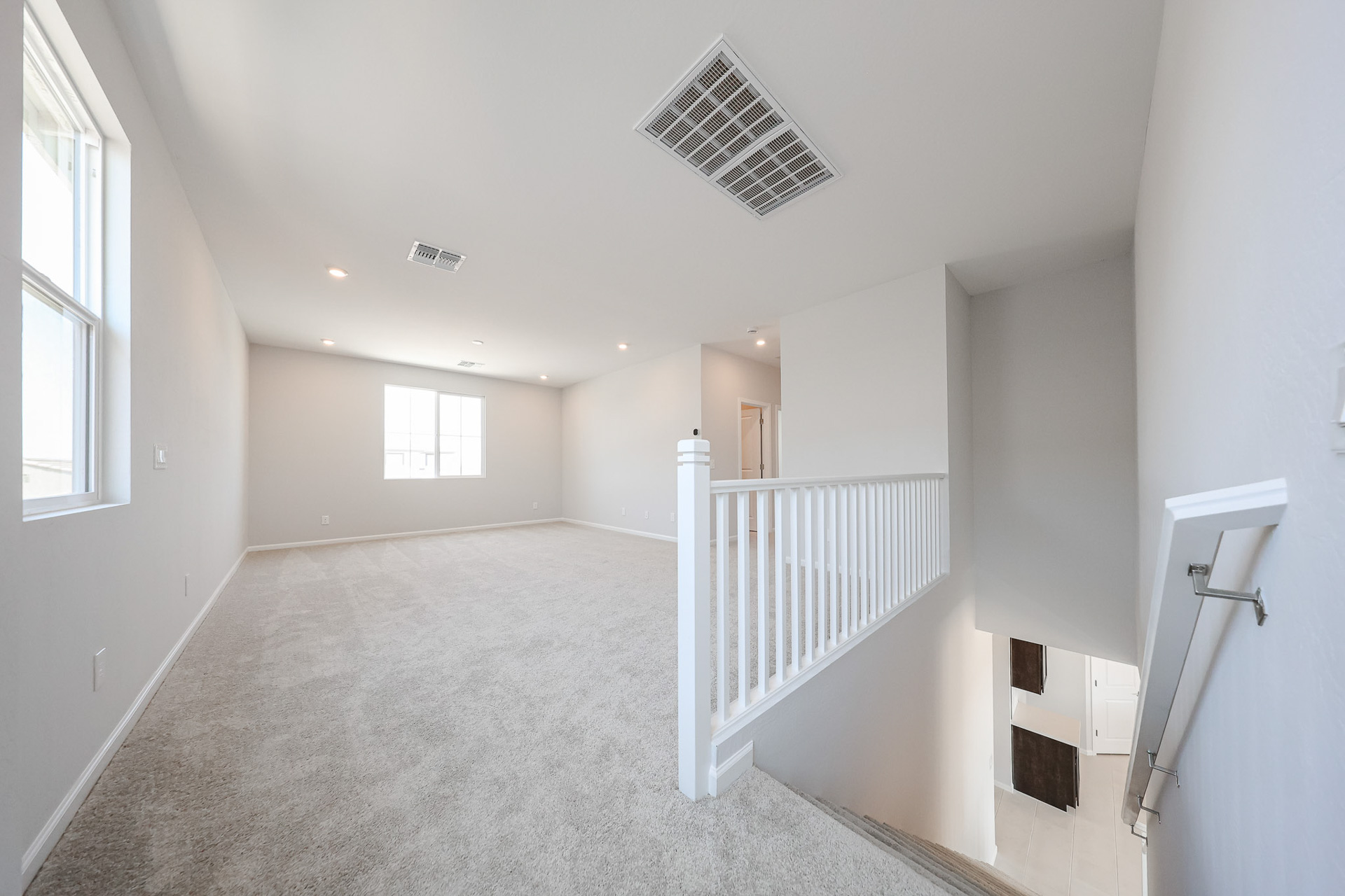 A hallway with white railings.