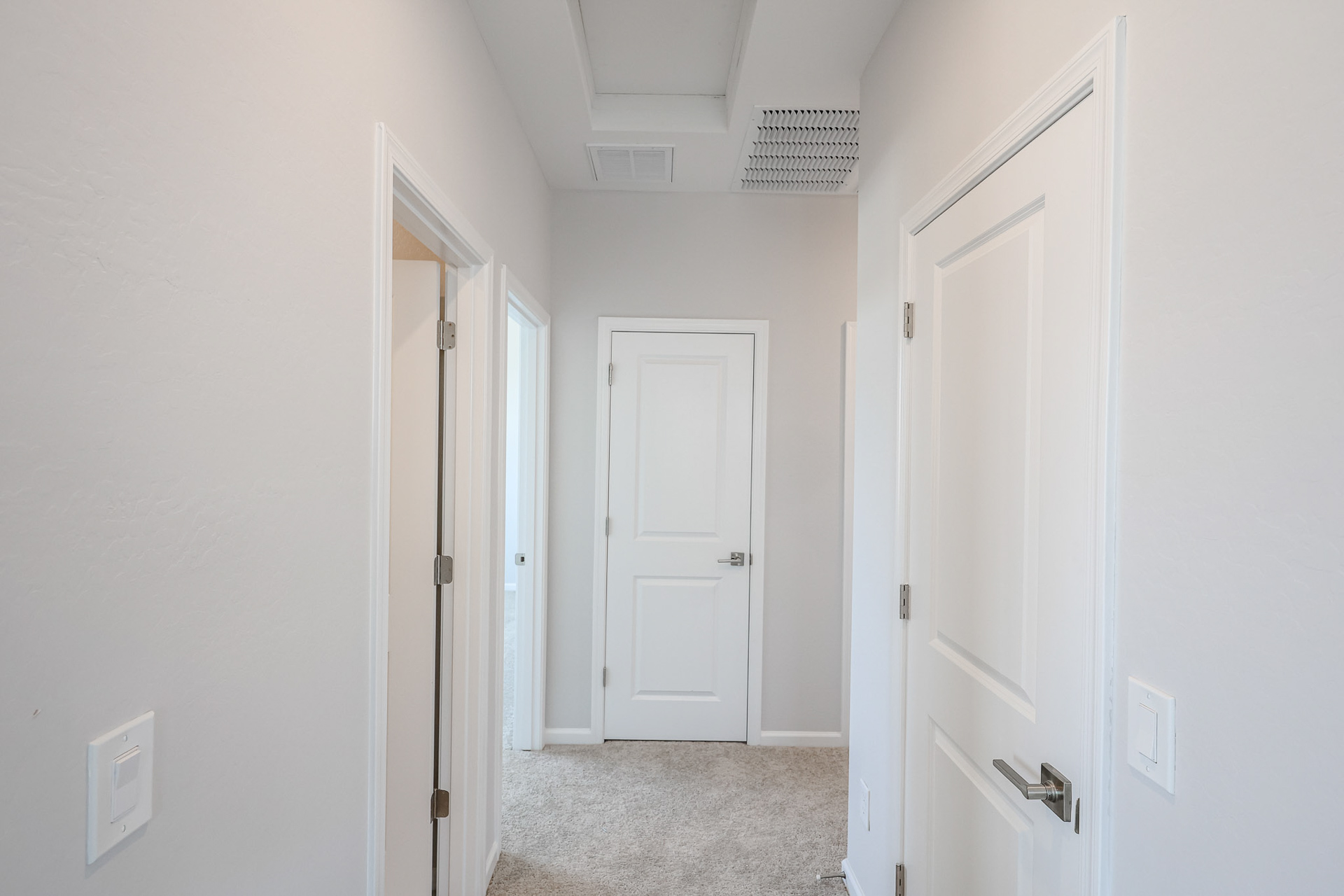 A hallway with white doors.