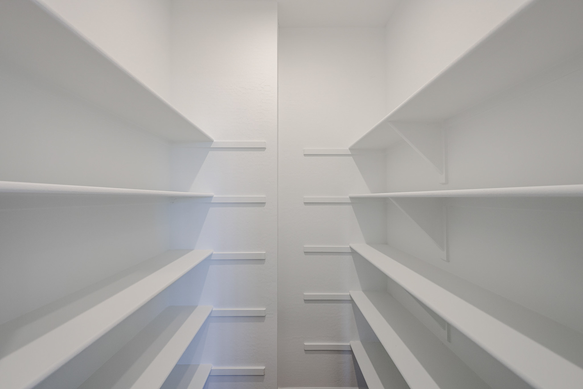 A white staircase with white walls.
