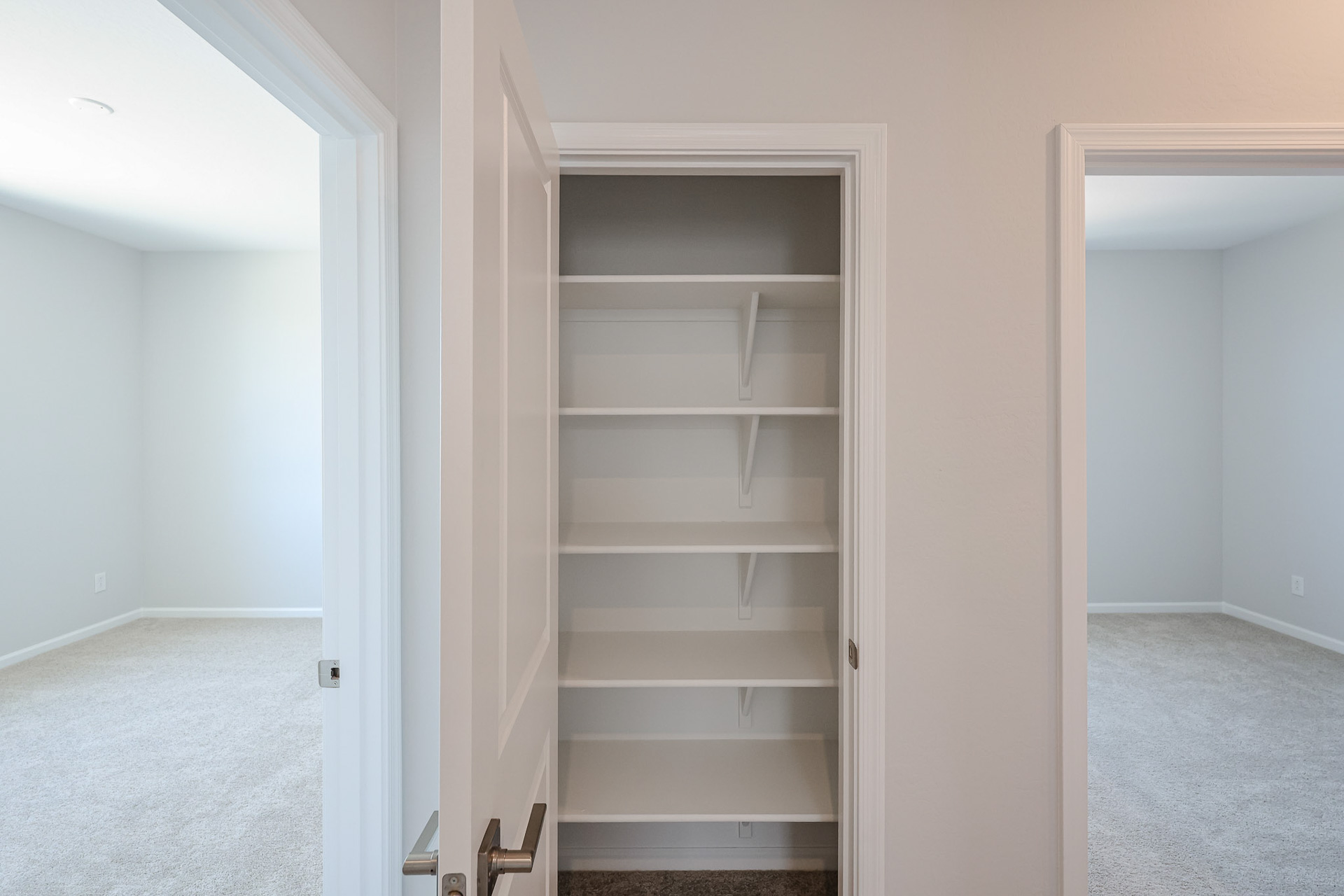 A white shelving unit in a room.