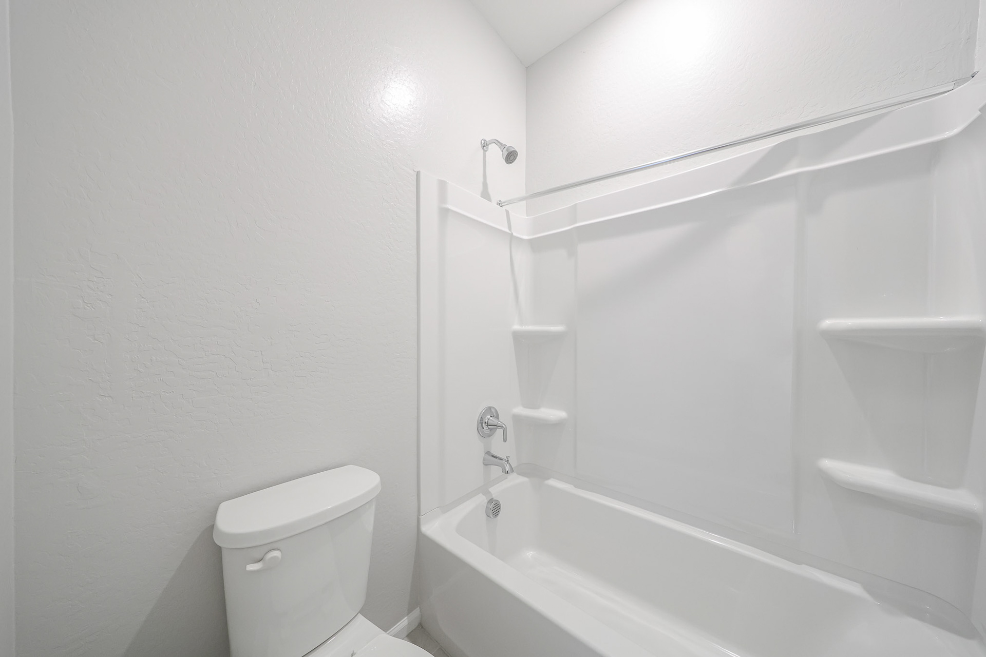 A bathroom with a tub toilet and sink.