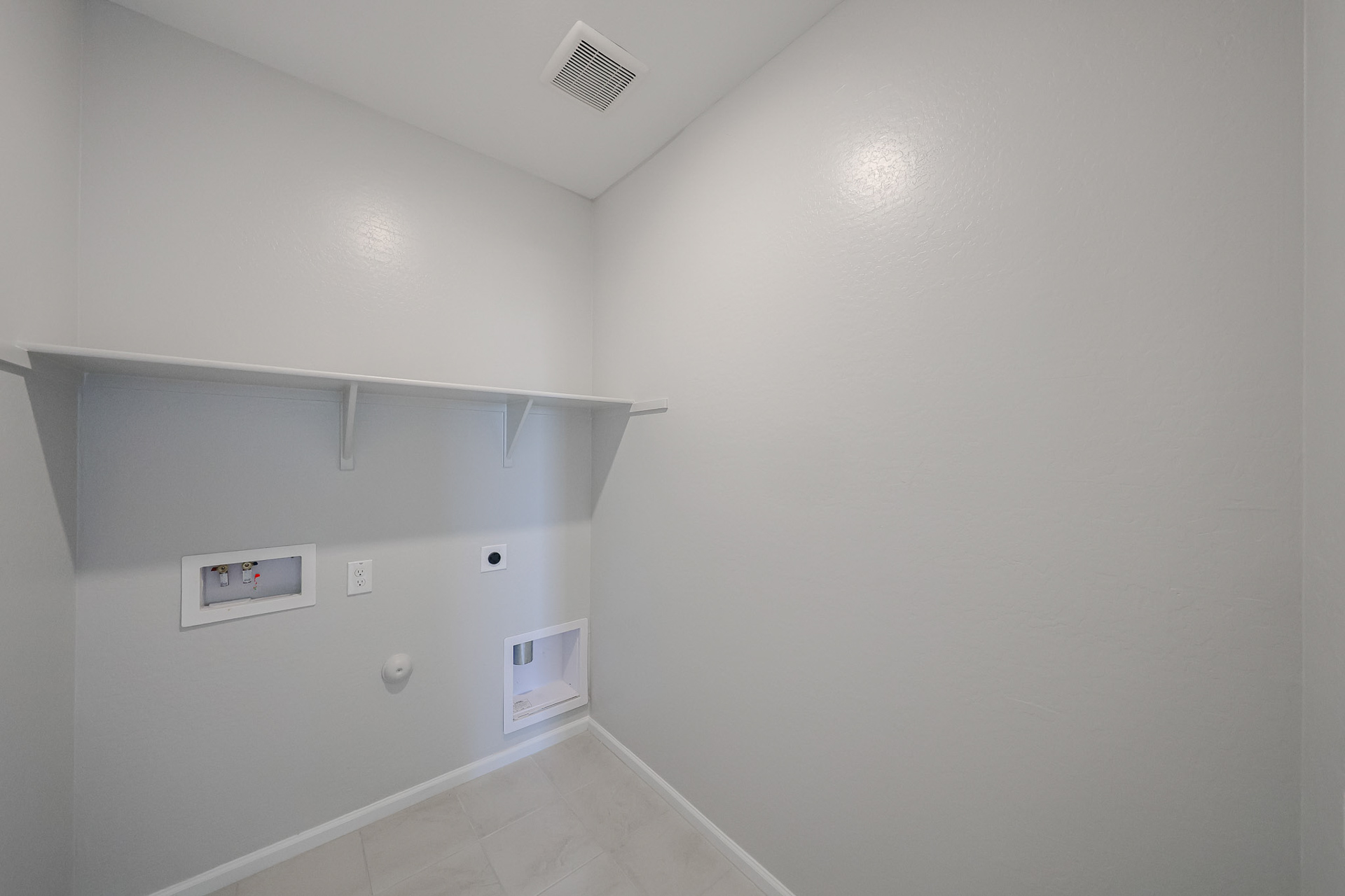 A white wall with a vent.